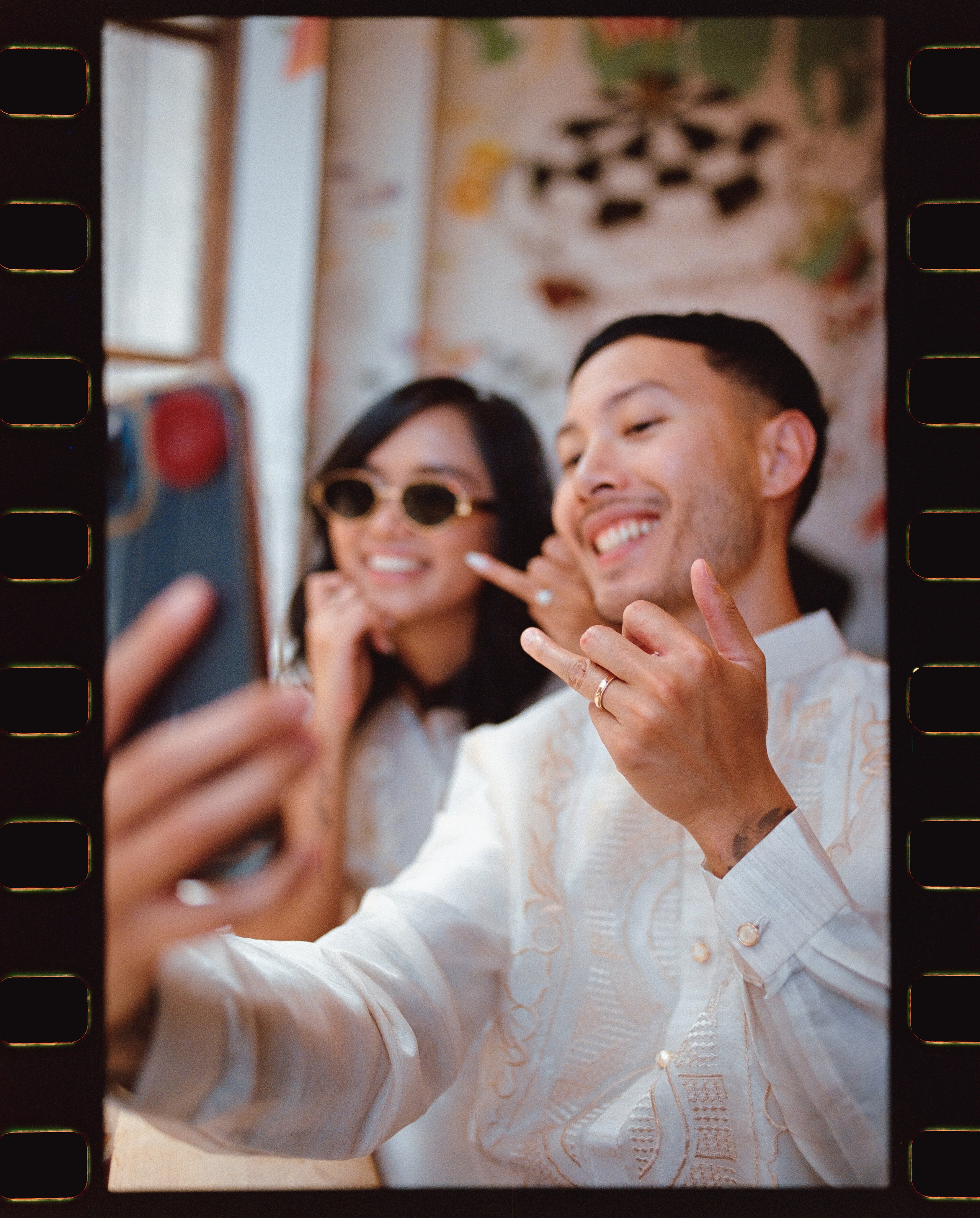 just married couple showing off their rings to the parents on the video call