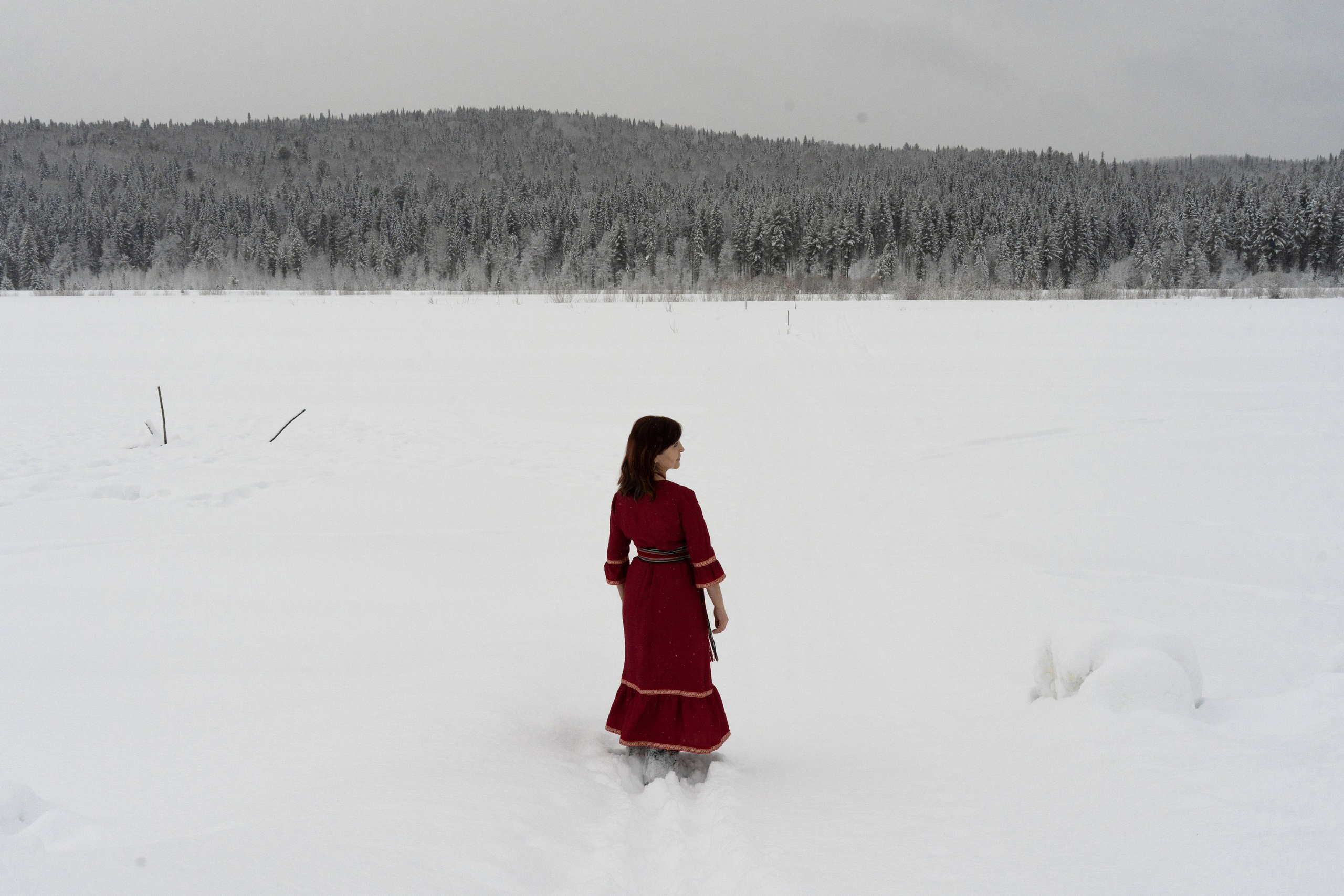 Lyubov Arbachakova stands on the frozen Mrass-Su River in the village of Ust-Kabyrza on March 8th, 2025. Despite the isolation and hardships of life in this remote Shor community, Lyubov actively participates in exhibitions, serves on juries, and speaks at public events. She has earned recognition for her artistic talent through decades of perseverance and meticulous work. Lyubov remains deeply rooted in her native land, valuing the cultural and natural environment of her home, and has no plans to relocate to a larger city for comfort or convenience.