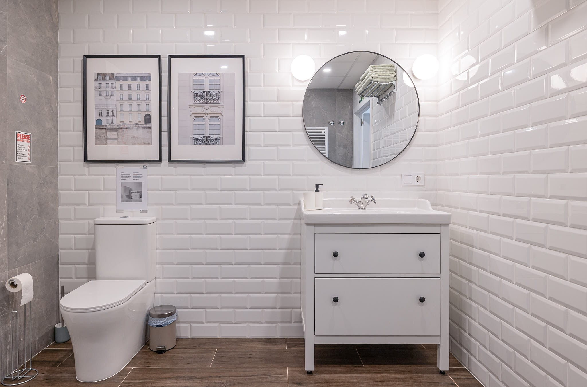 Modern bathroom with white tiles in an apartment in Valencia, interior photography