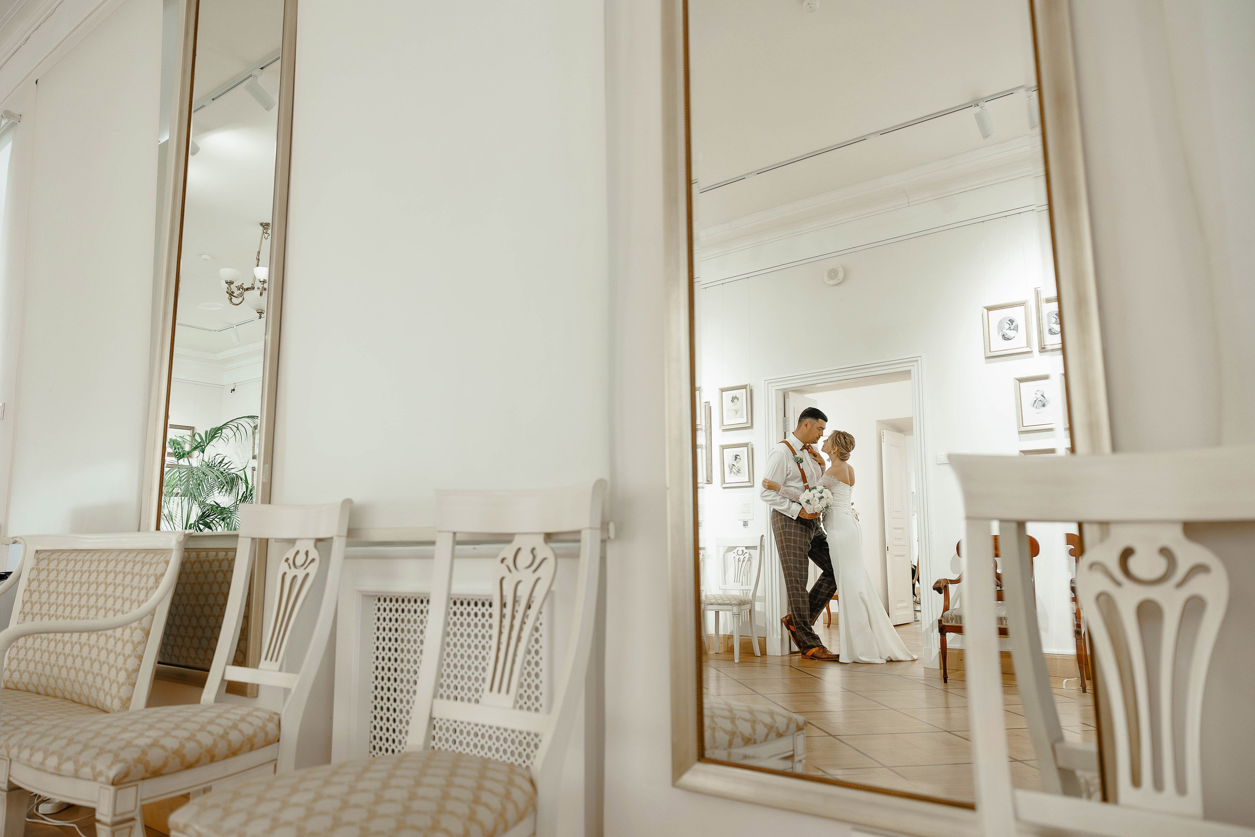 Отражение жениха и невесты в красивом интерьере музея Веневитинова в Воронеже