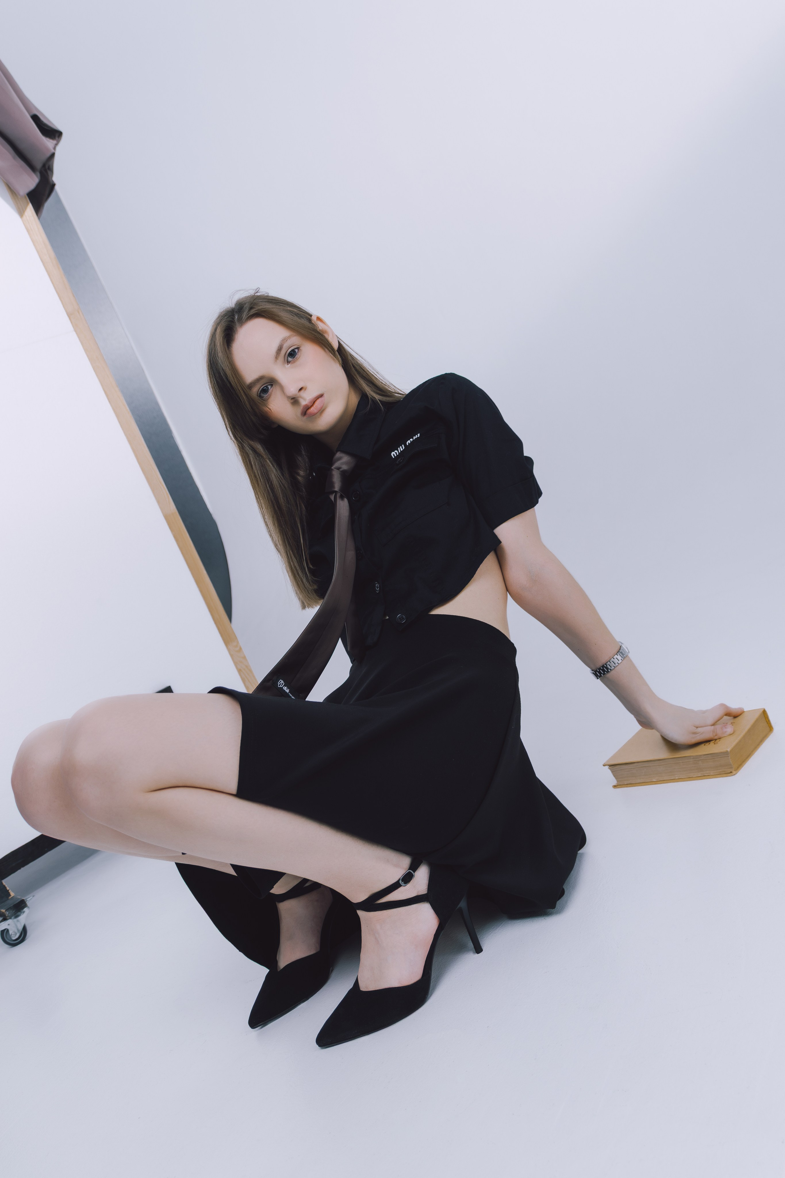 Модель в расслабленной позе на хромированном кресле — эстетика современности.