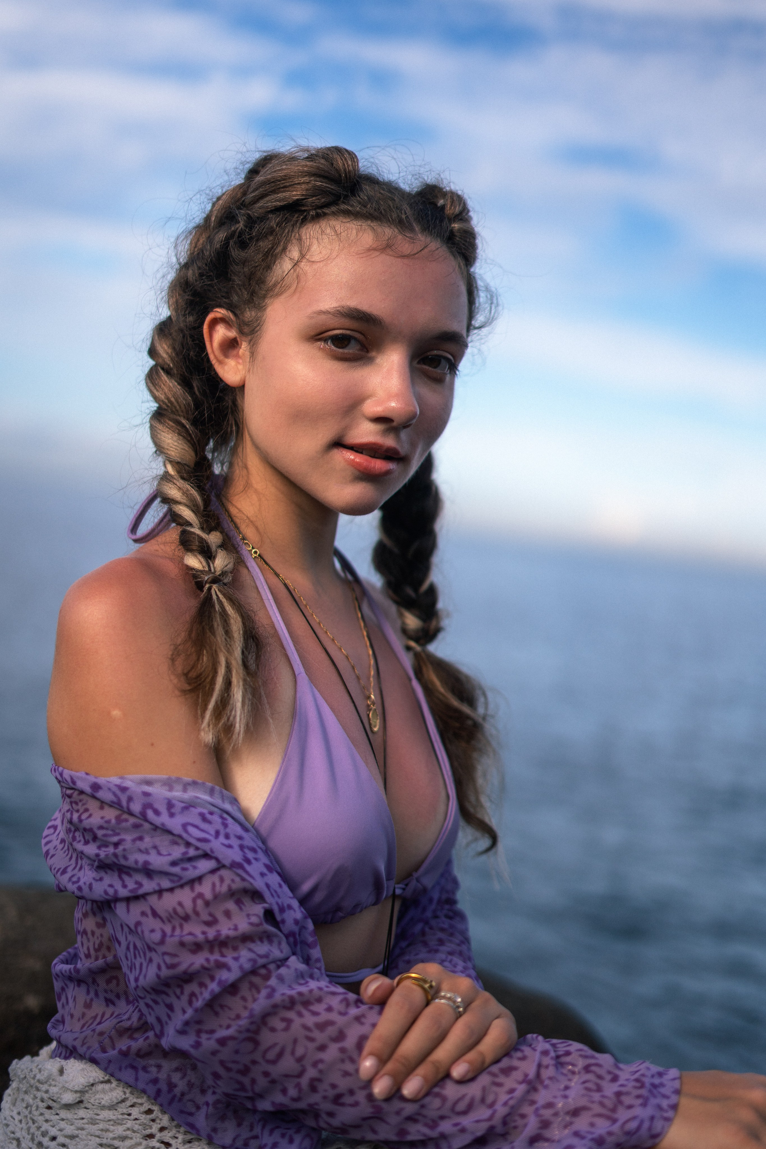 a young girl in a purple swimsuit surrounded by ocean waves