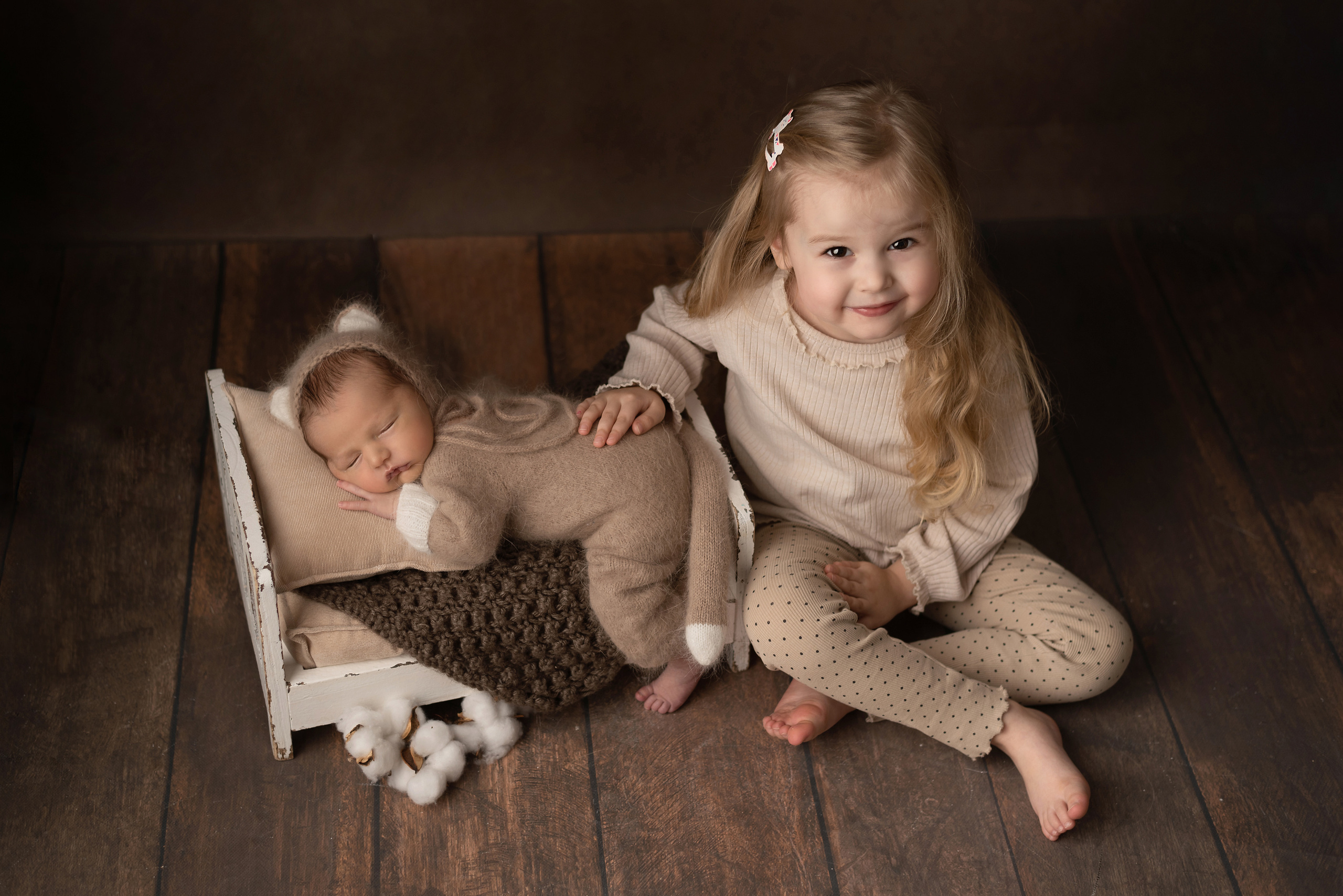 Sister holding her newborn brother