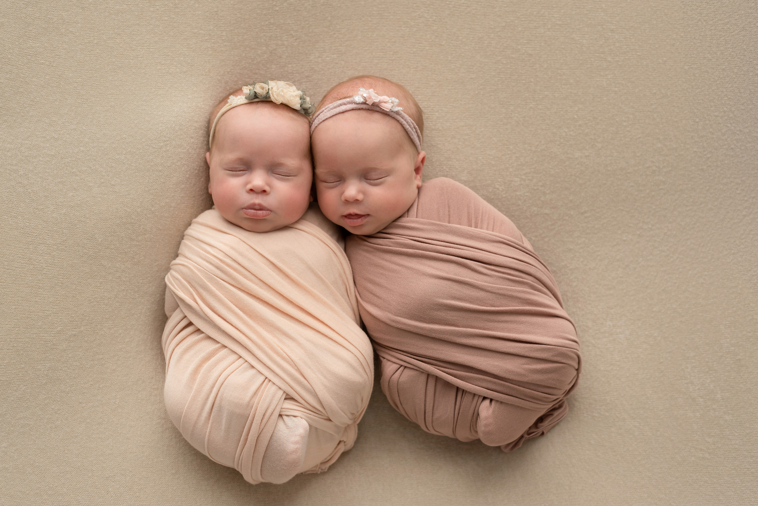Newborn twins lie next to each other