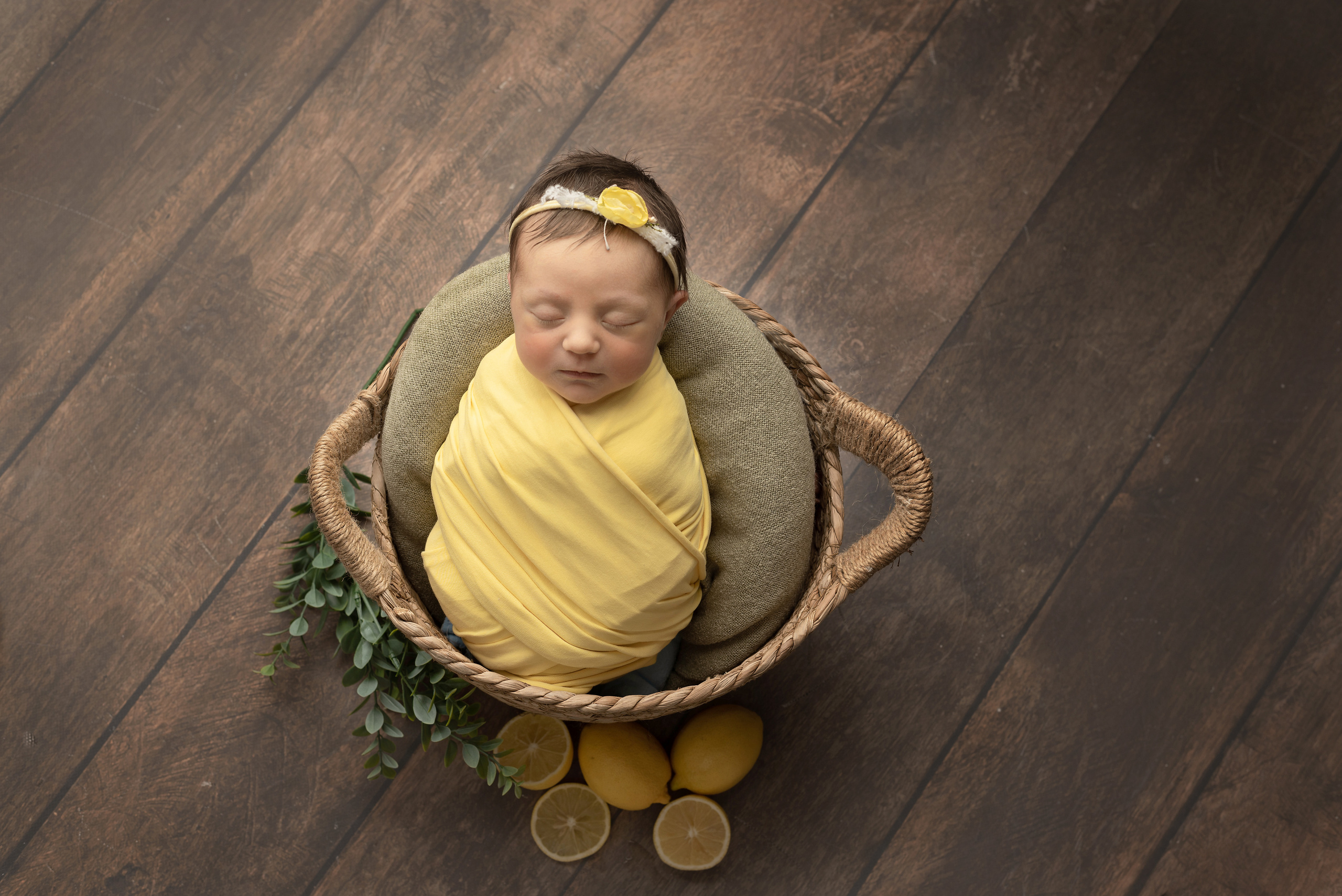 Baby in a basket of lemons