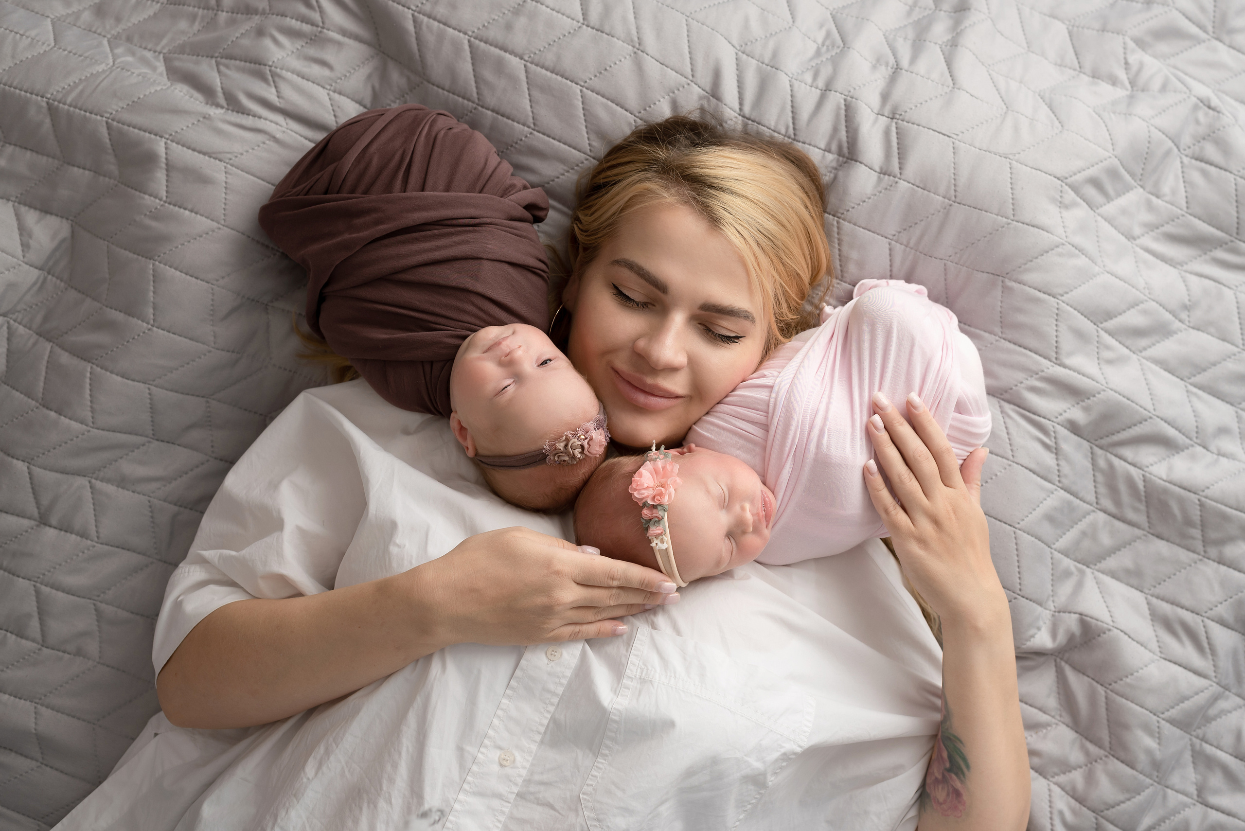 Mom hugs newborn twins