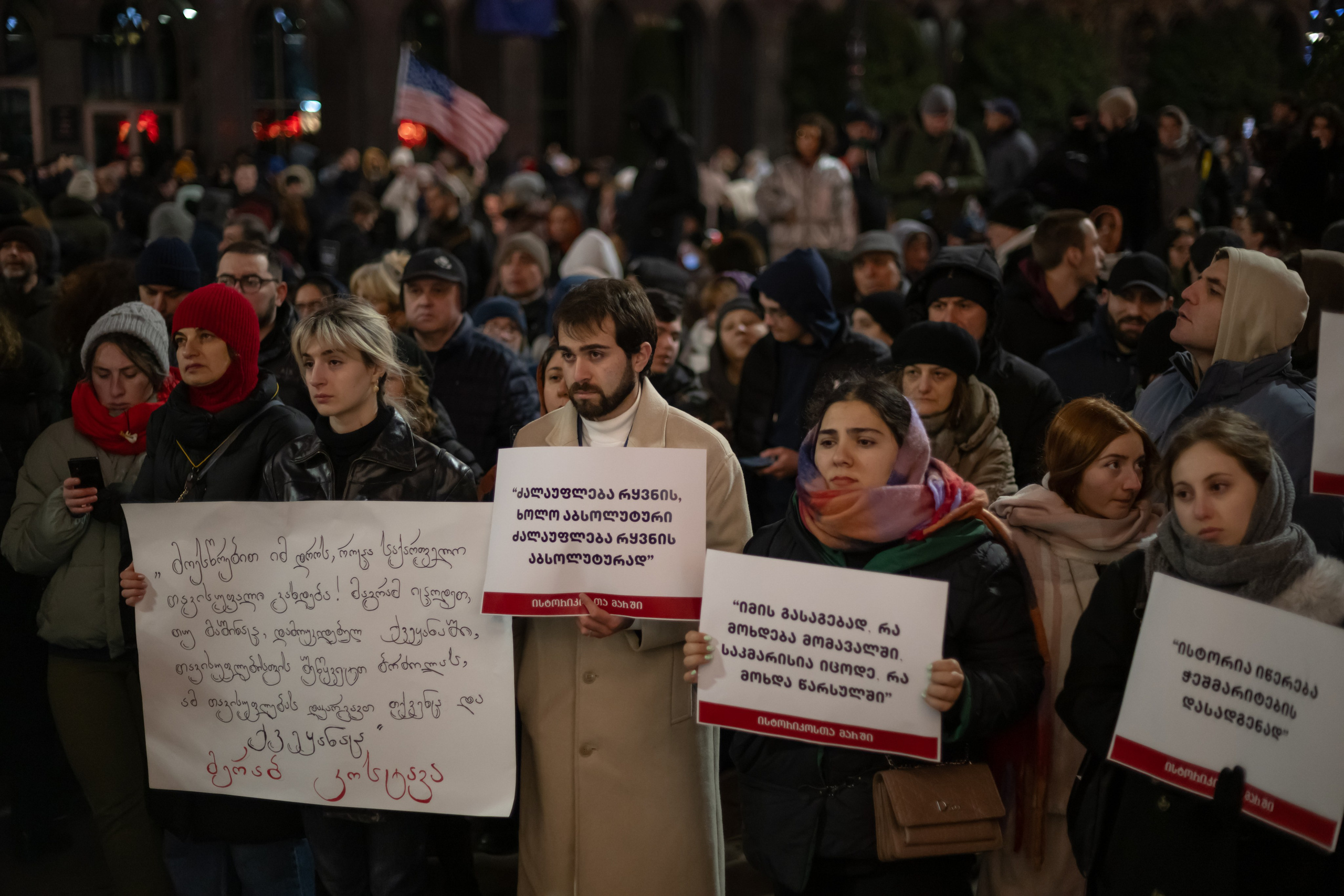 Protesters hold signs during a demonstration near the parliament building against the government's suspension of EU membership talks and after Mikheil Kavelashvili's election as president in Tbilisi. Tbilisi, December 17, 2024.