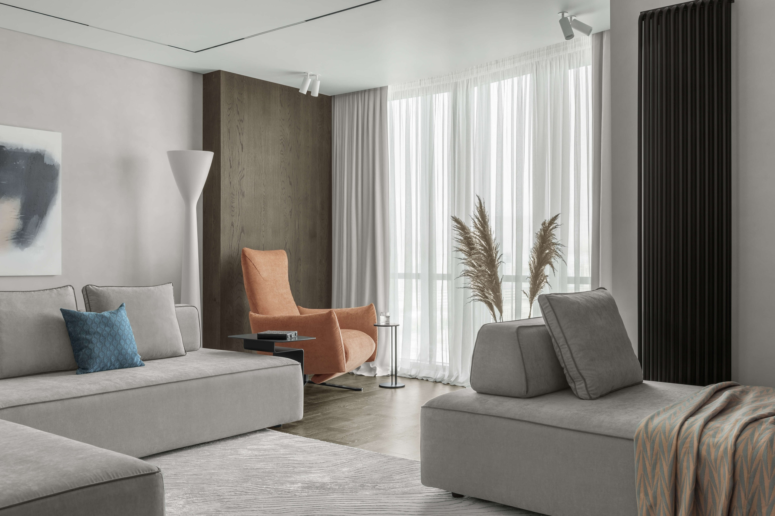 Фотография интерьера гостиной в ЖК «Времена года» — серые диваны Samoa, акцентное кресло Minotti, ковёр B&B Italia и торшер Flos.