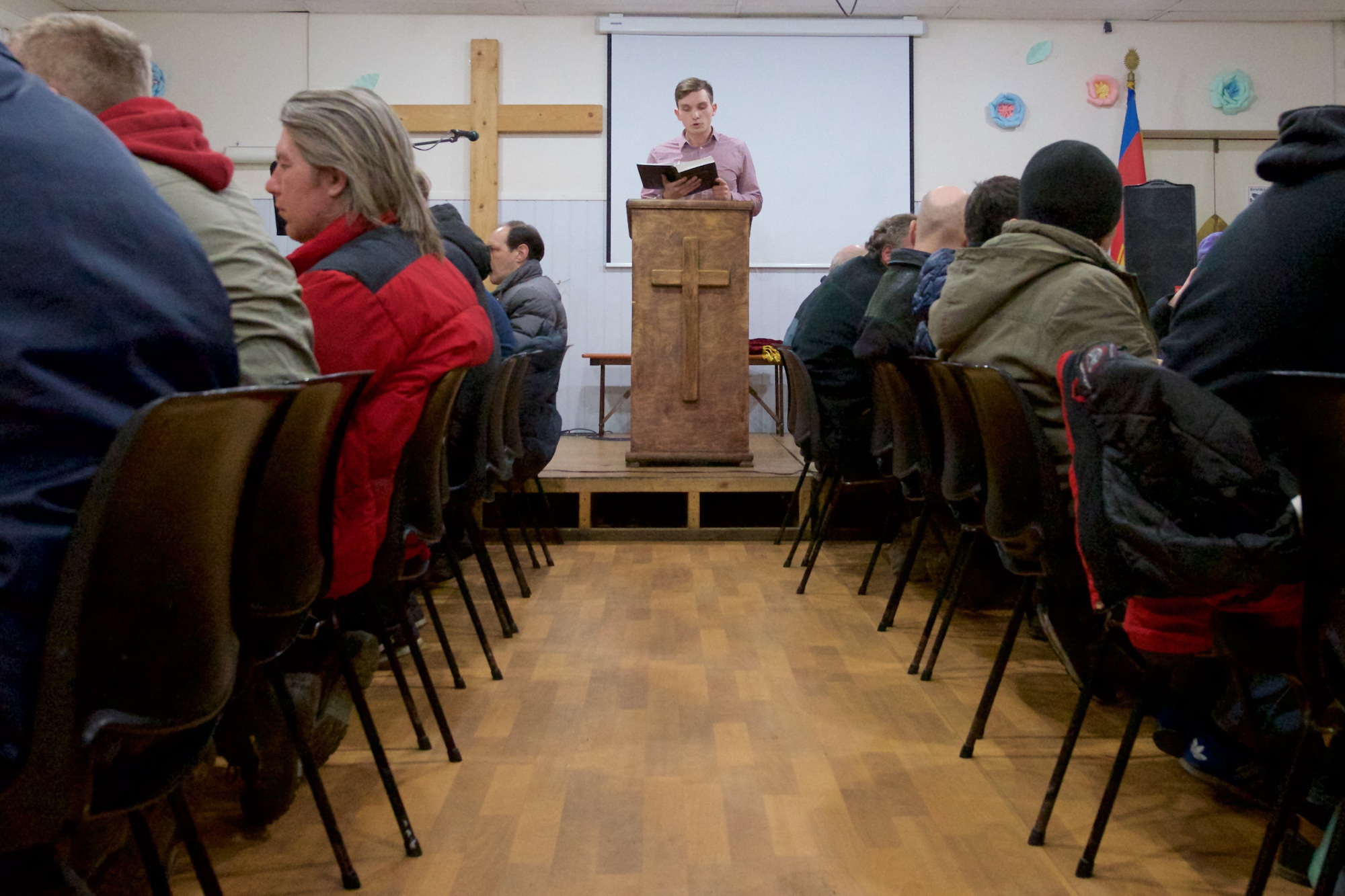 Altarnik Igor Pavlov reads a sermon to the homeless. Annenkirche volunteers participate in a program for feeding the homeless, helping the St. Petersburg Salvation Army. 