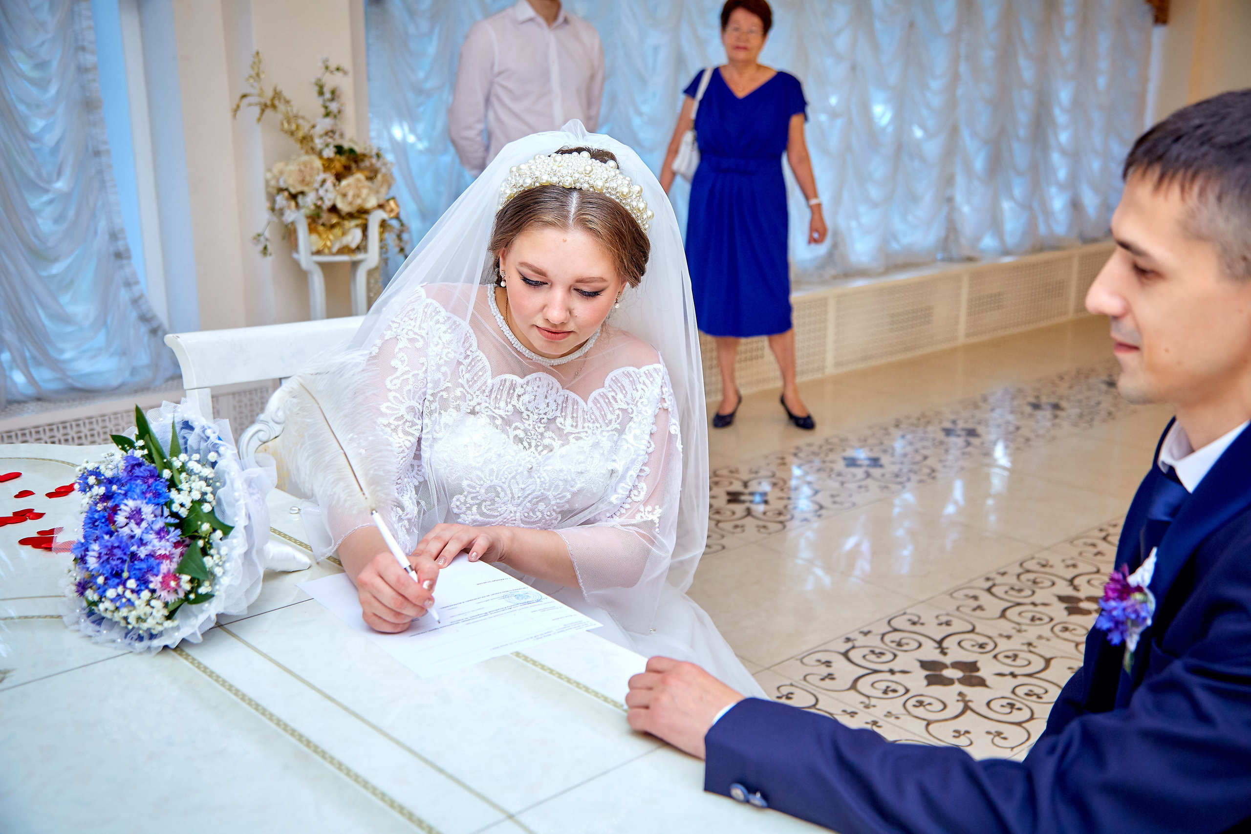 Невеста расписывается в журнале регистрации