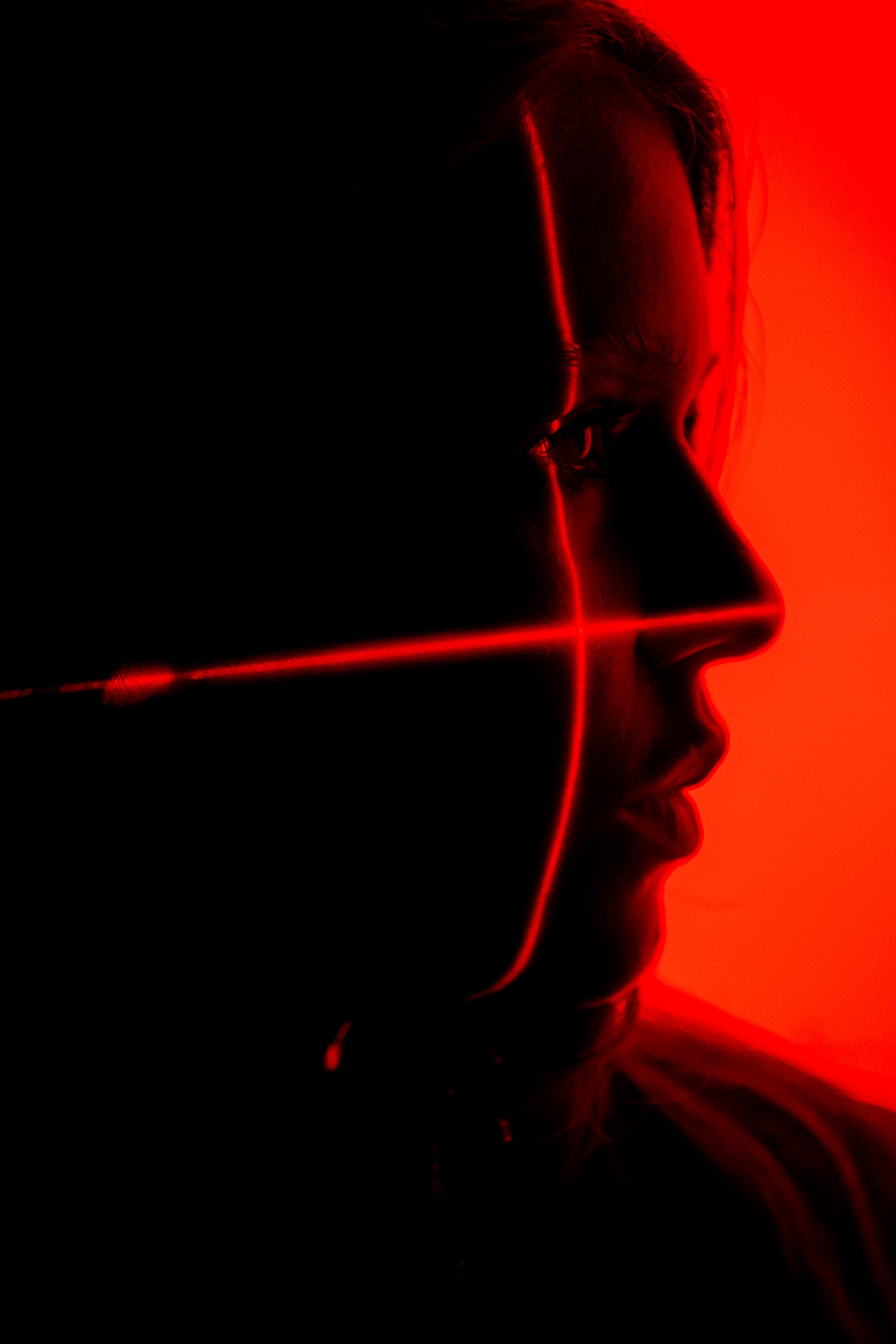 Силуэт портрета девушки с красным фоном и красными линиями на лице