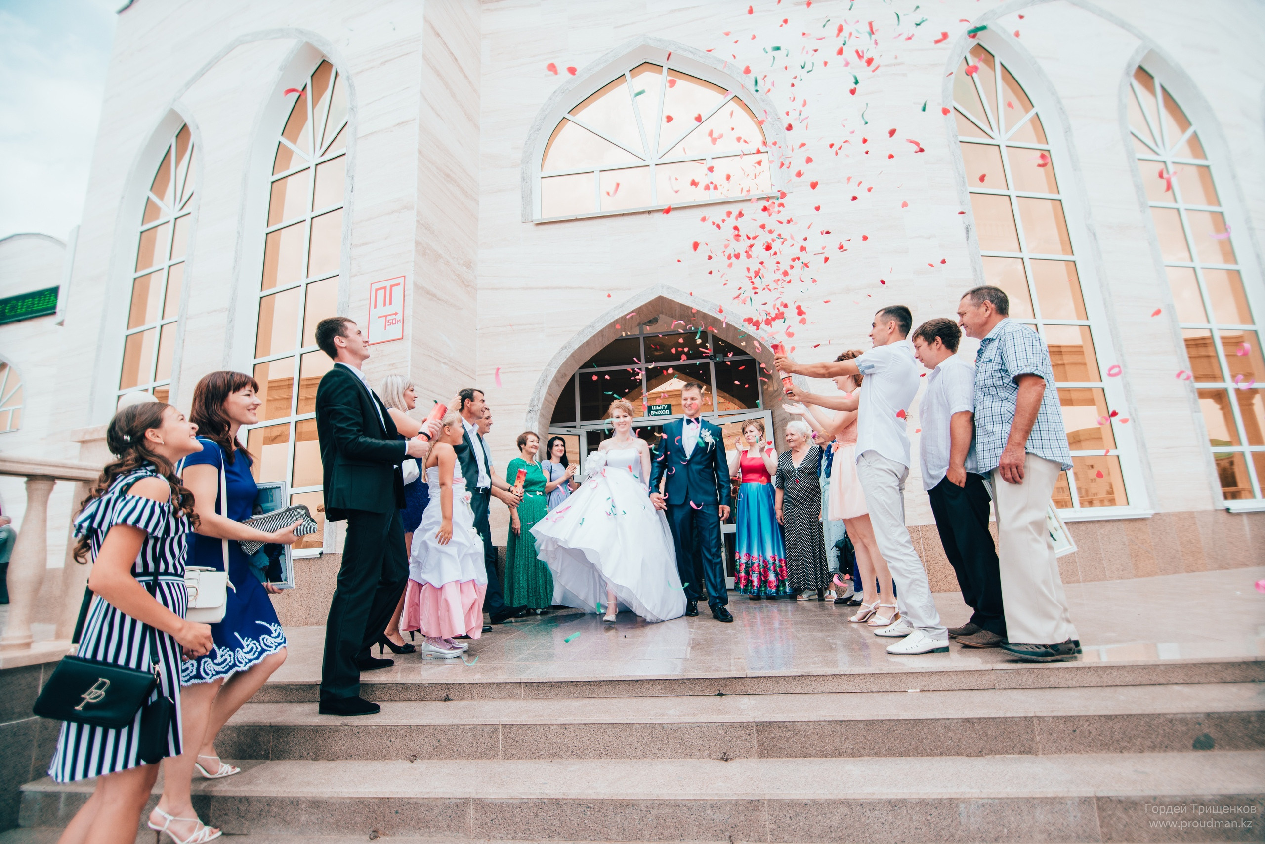 Жених с невестой выходят из ЗАГСа