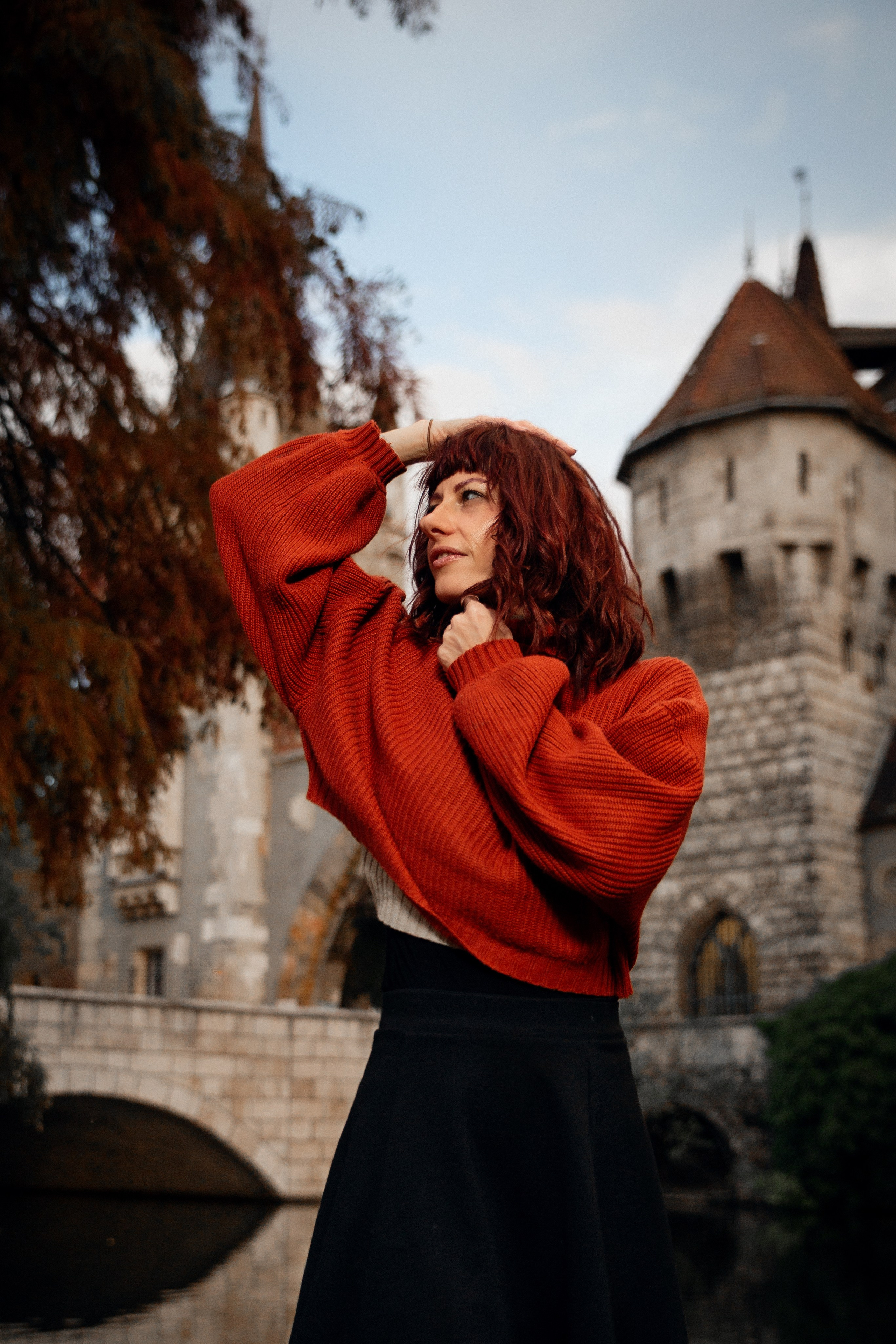 a girl in red against the backdrop of a castle Vajdahunyad