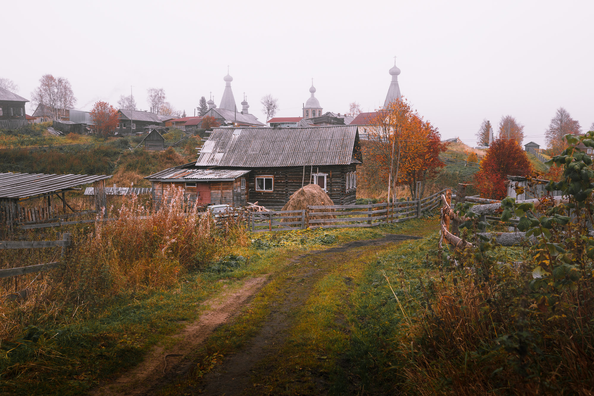 Деревенская улица, стог сена во дворе деревянного дома. 