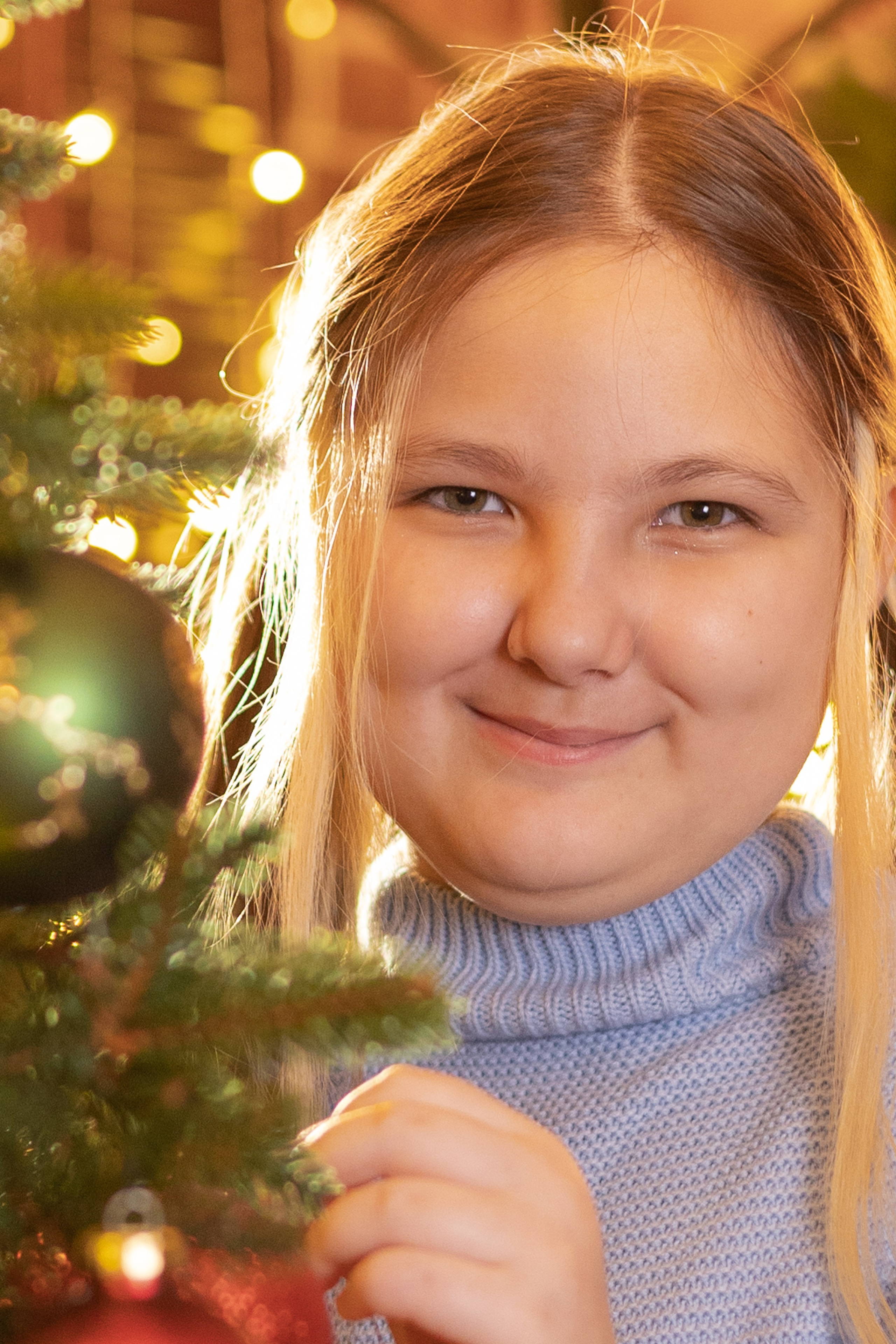 Девушка стоит рядом с елкой новогодней