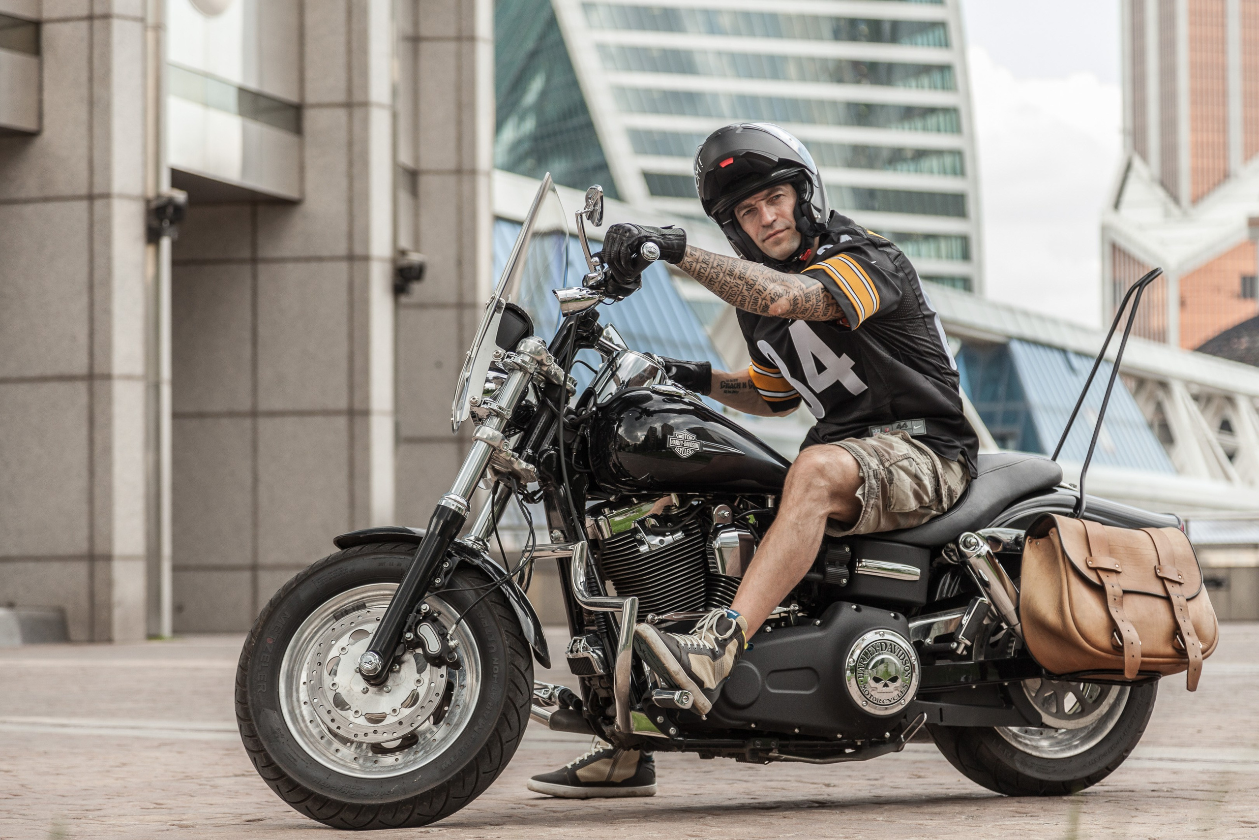 Location portrait of a biker on a Harley Davidson motorcycle in city landscape - photographer Andrey Dunin