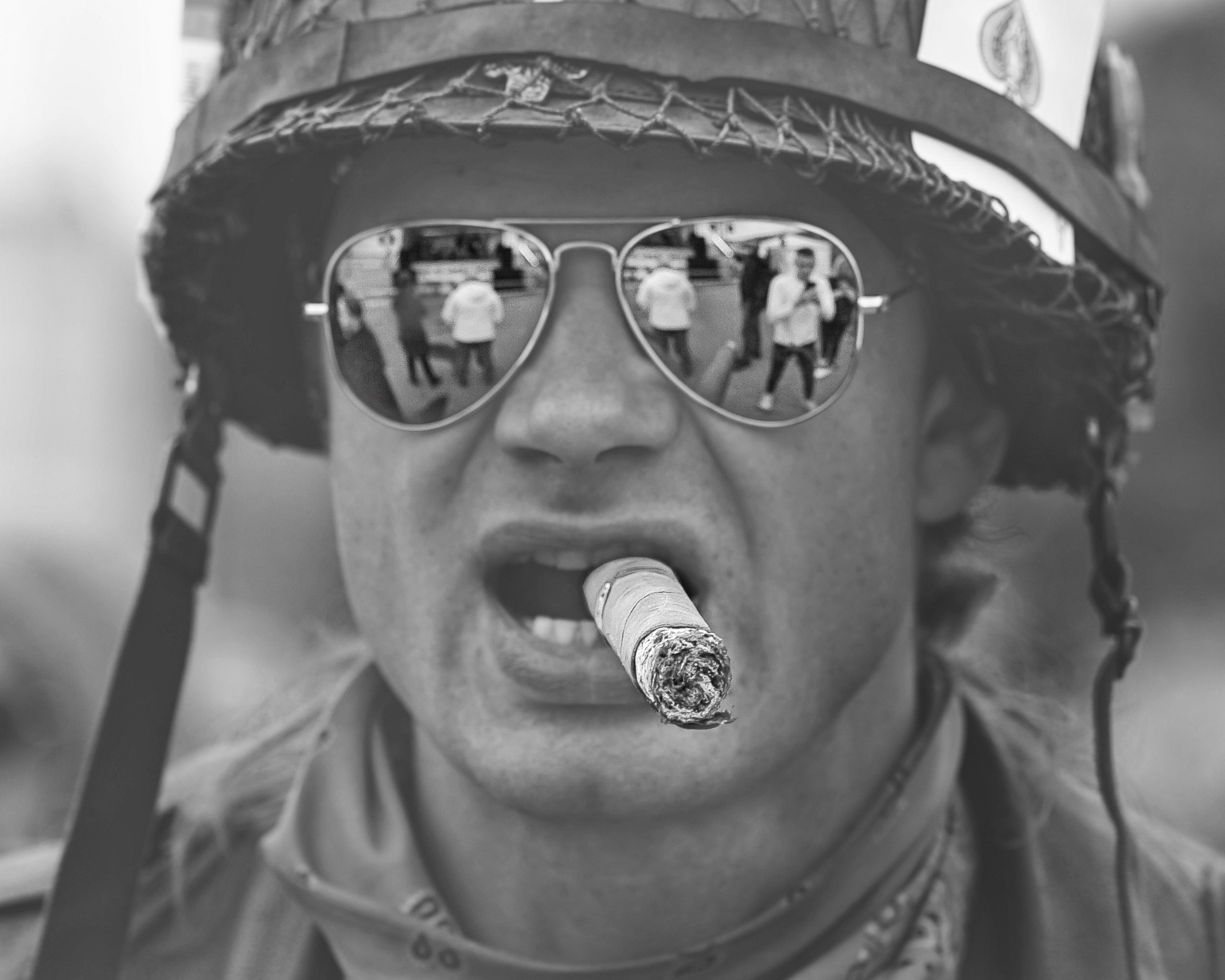 Мужчина с сигарой в зубах и военной каске