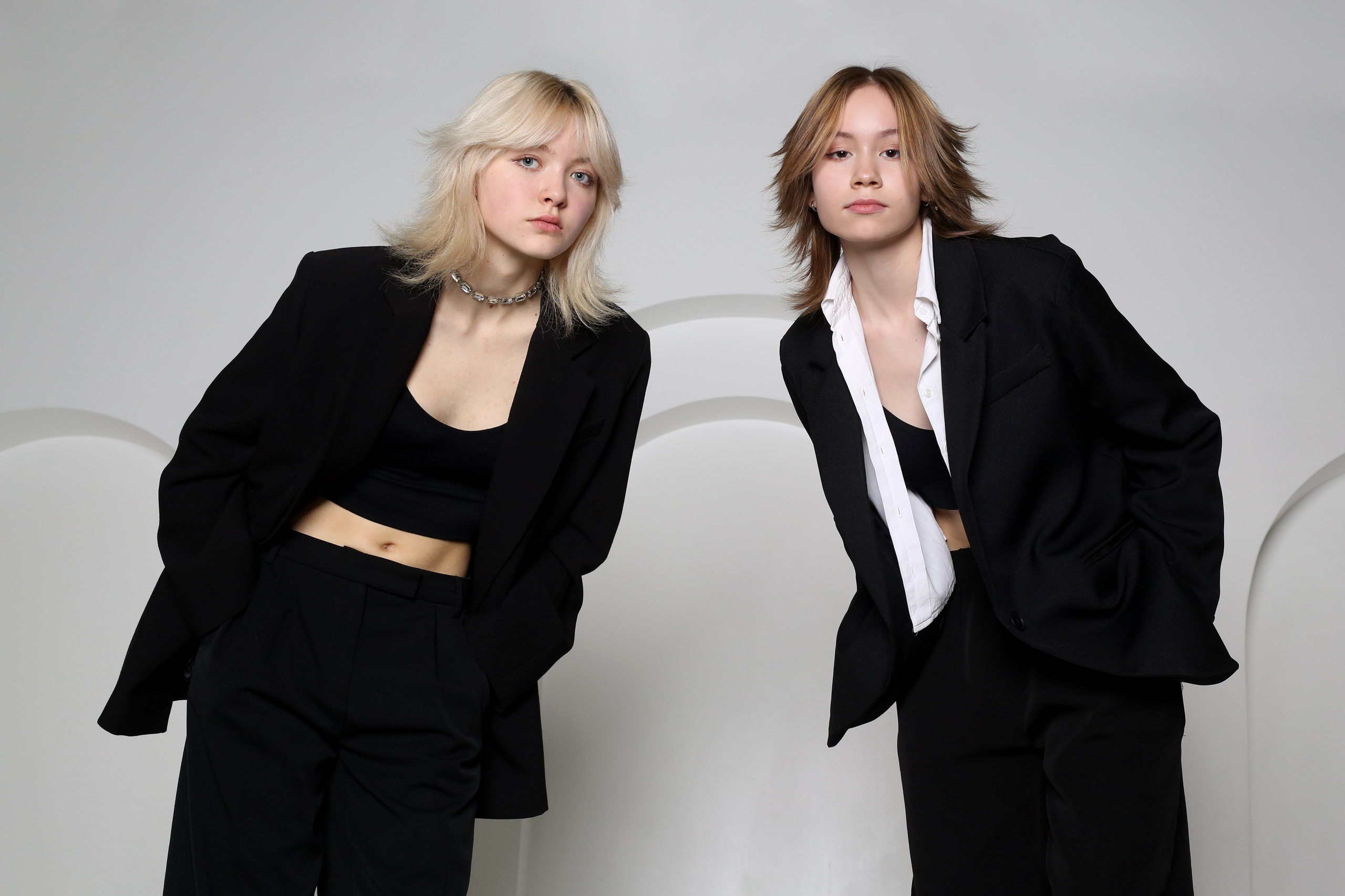 Фотосессия «Геометрия» в Перми: две девушки в черных костюмах стоят на белом фоне