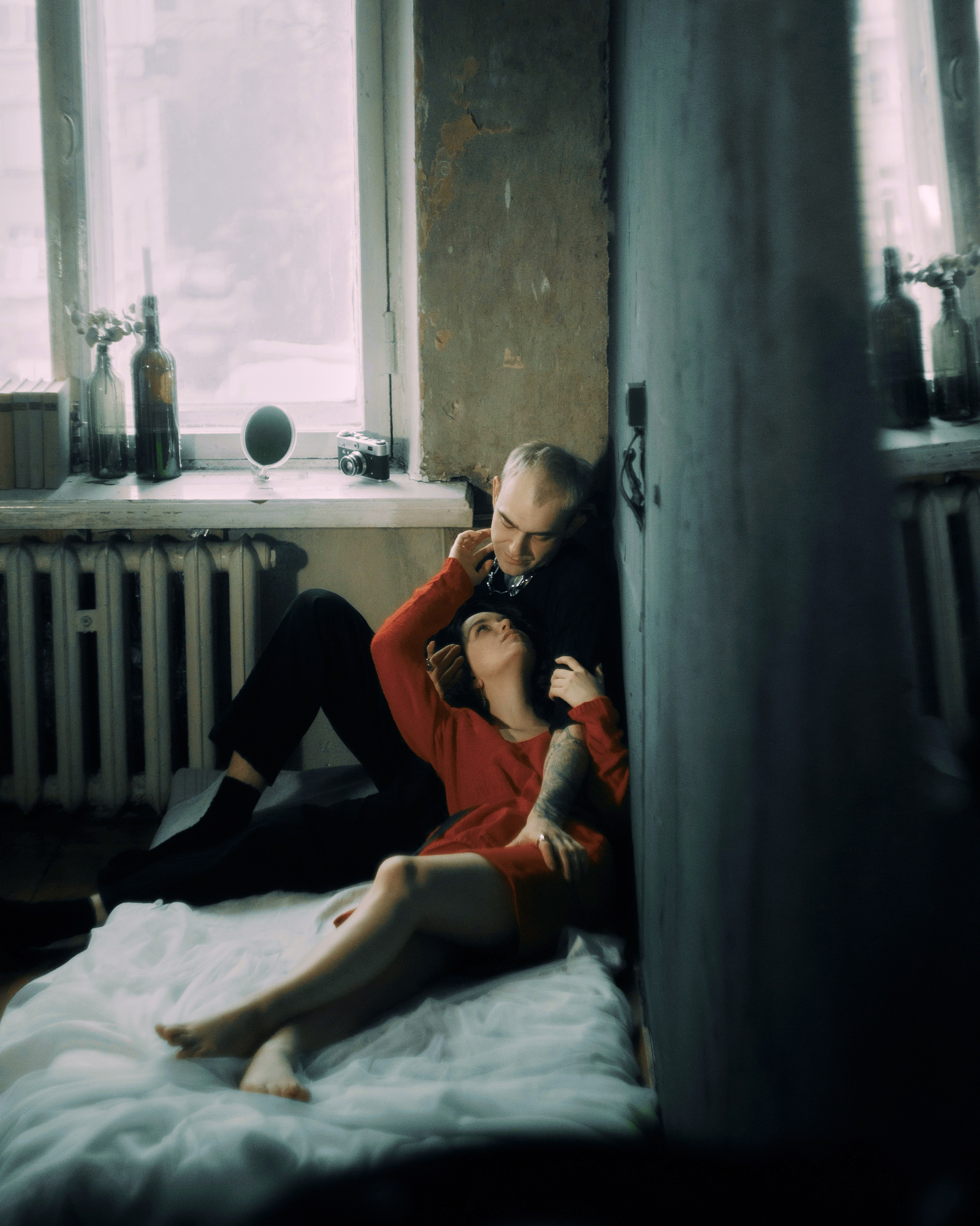 Лав стори фотосессия в Петербурге — пара на матрасе у окна, винтажная комната, пленочная атмосфера, фотограф СПб