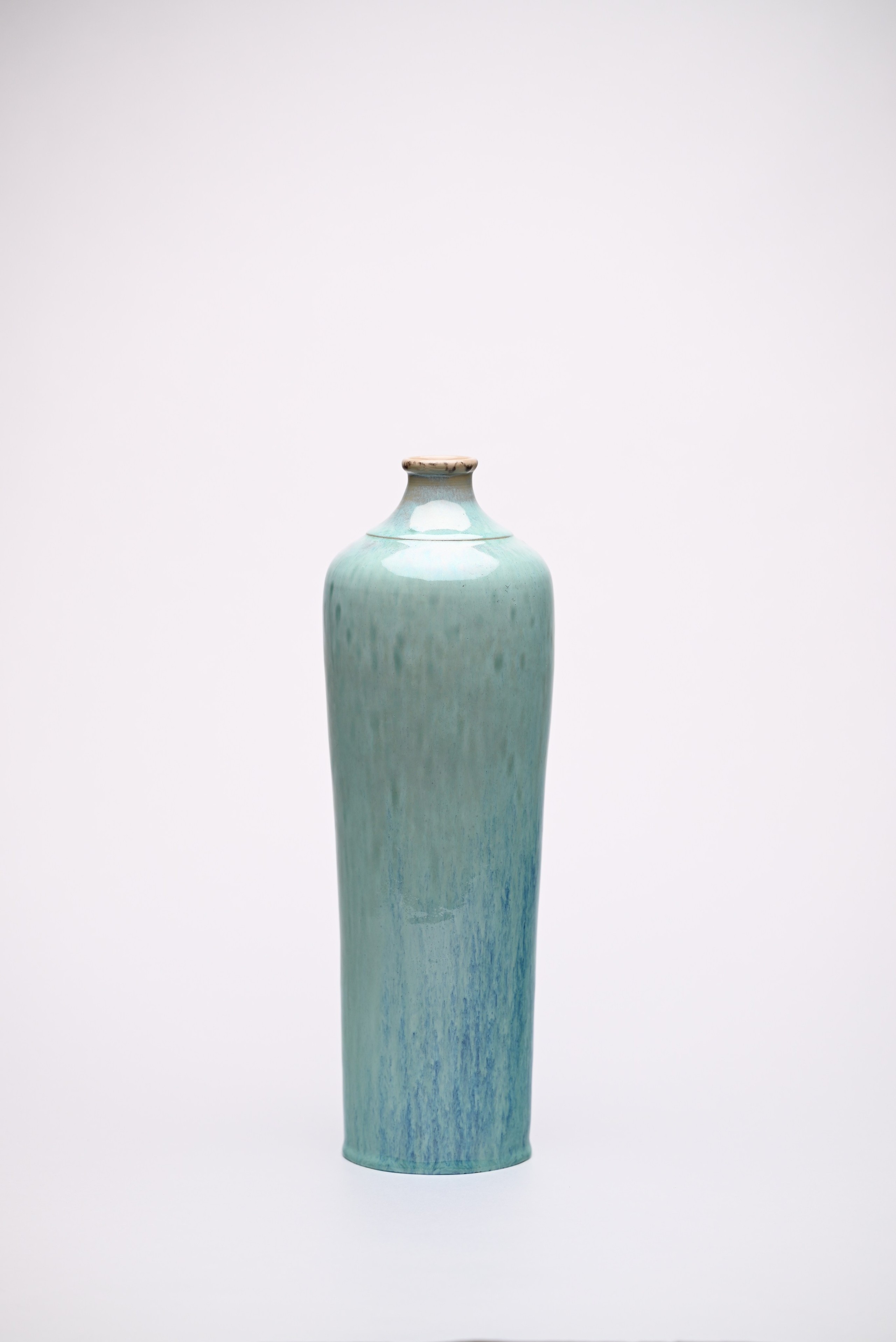 Vase “Hydor”. Ceramics, glazes.Height 42 cm.The form is constructed as a vertical flow. The glaze creates directional traces that register the movement of the medium within a stable volume.