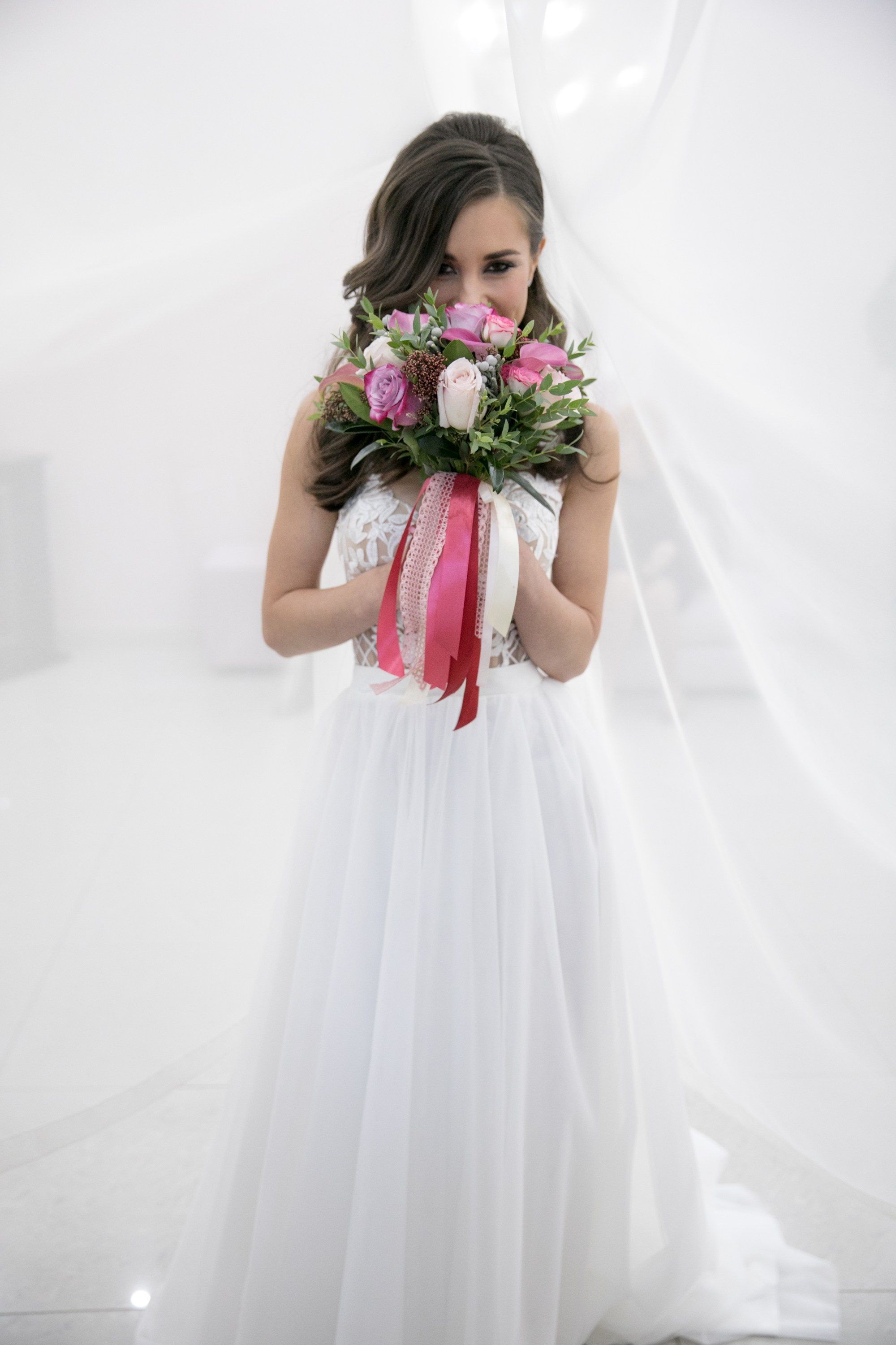 Wedding photo session. Bride in white dress with bouquet in hands