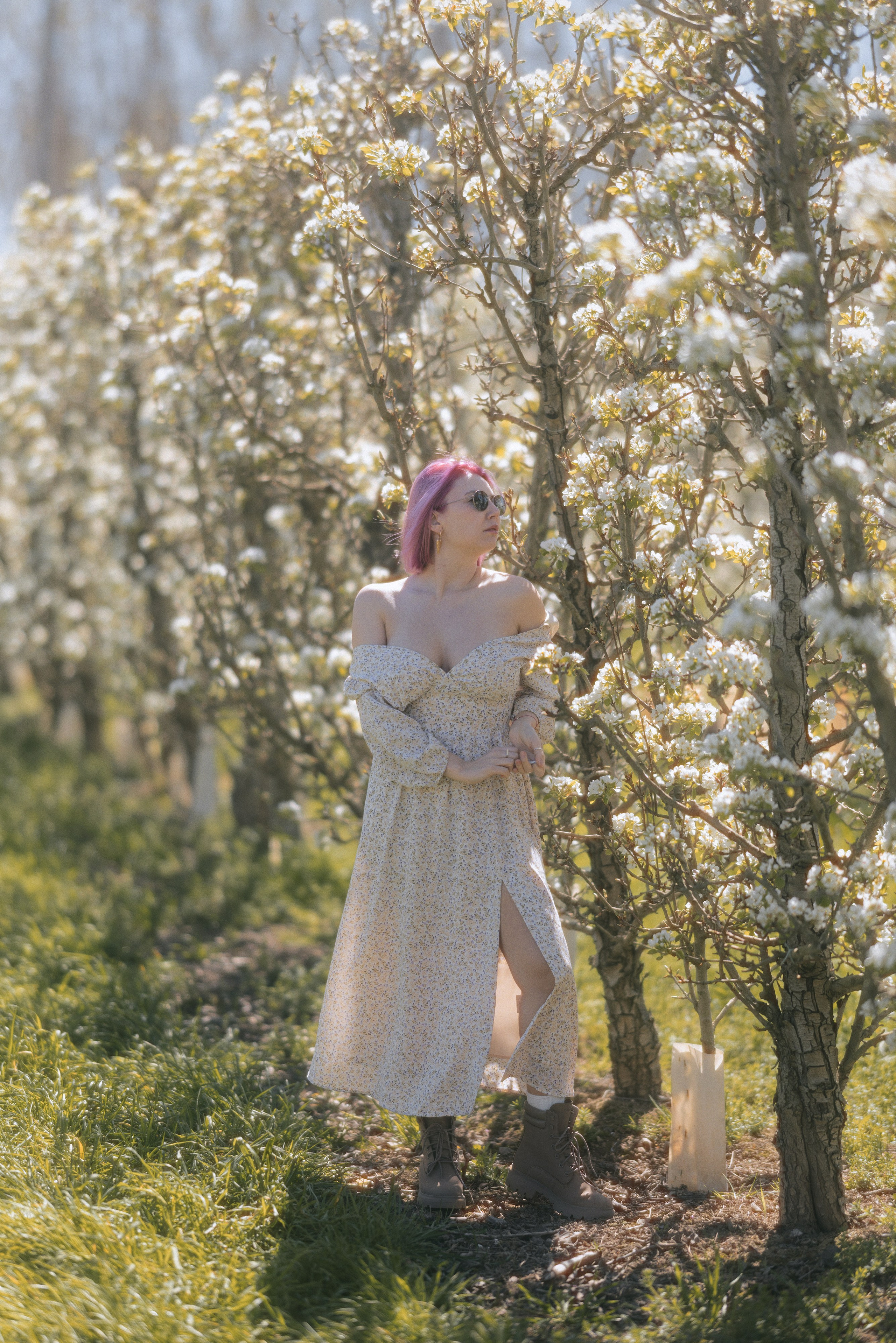 Natural light portrait of a woman in a blooming garden in Barcelona, fashion photoshoot