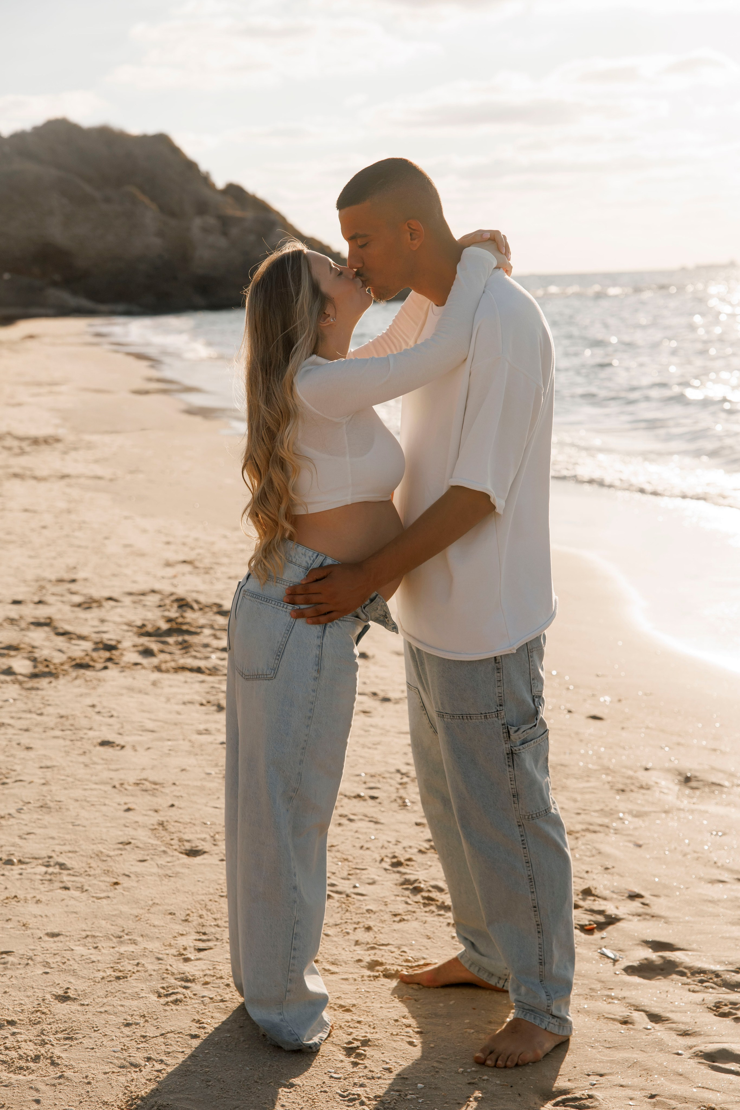 Pregnancy photoshoot near the sea. Wedding and family photographer