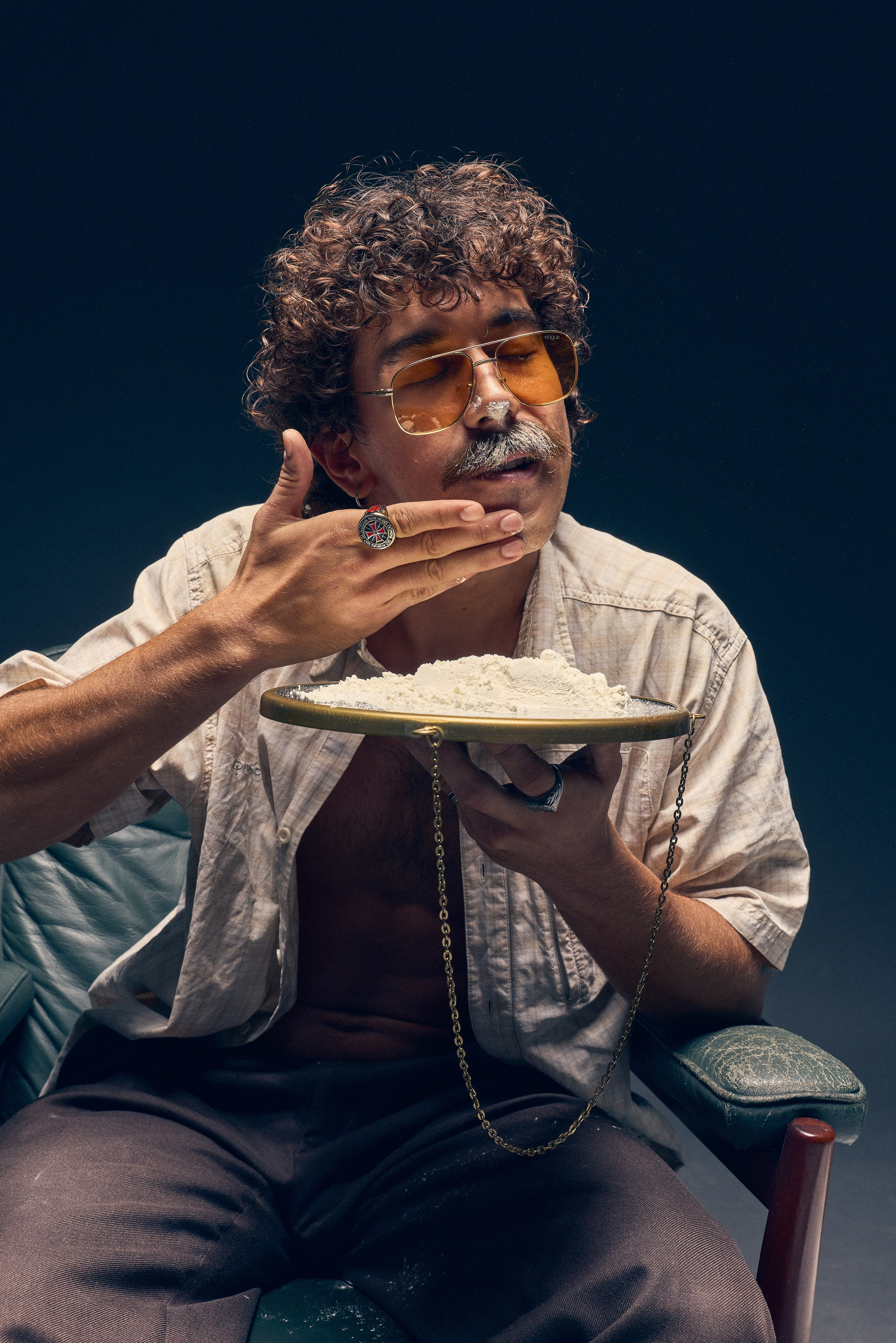 Dramatic artistic photo of man with sunglasses and jewelry