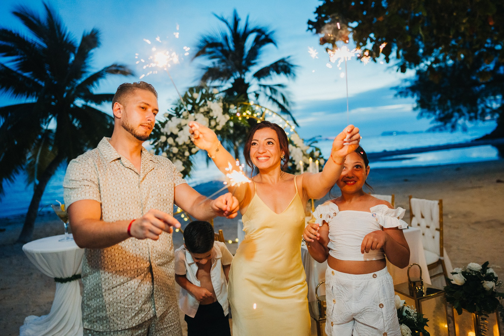 Romantic escape wedding in Koh Samui, Thailand with bride, groom and children on a beautiful tropical beach