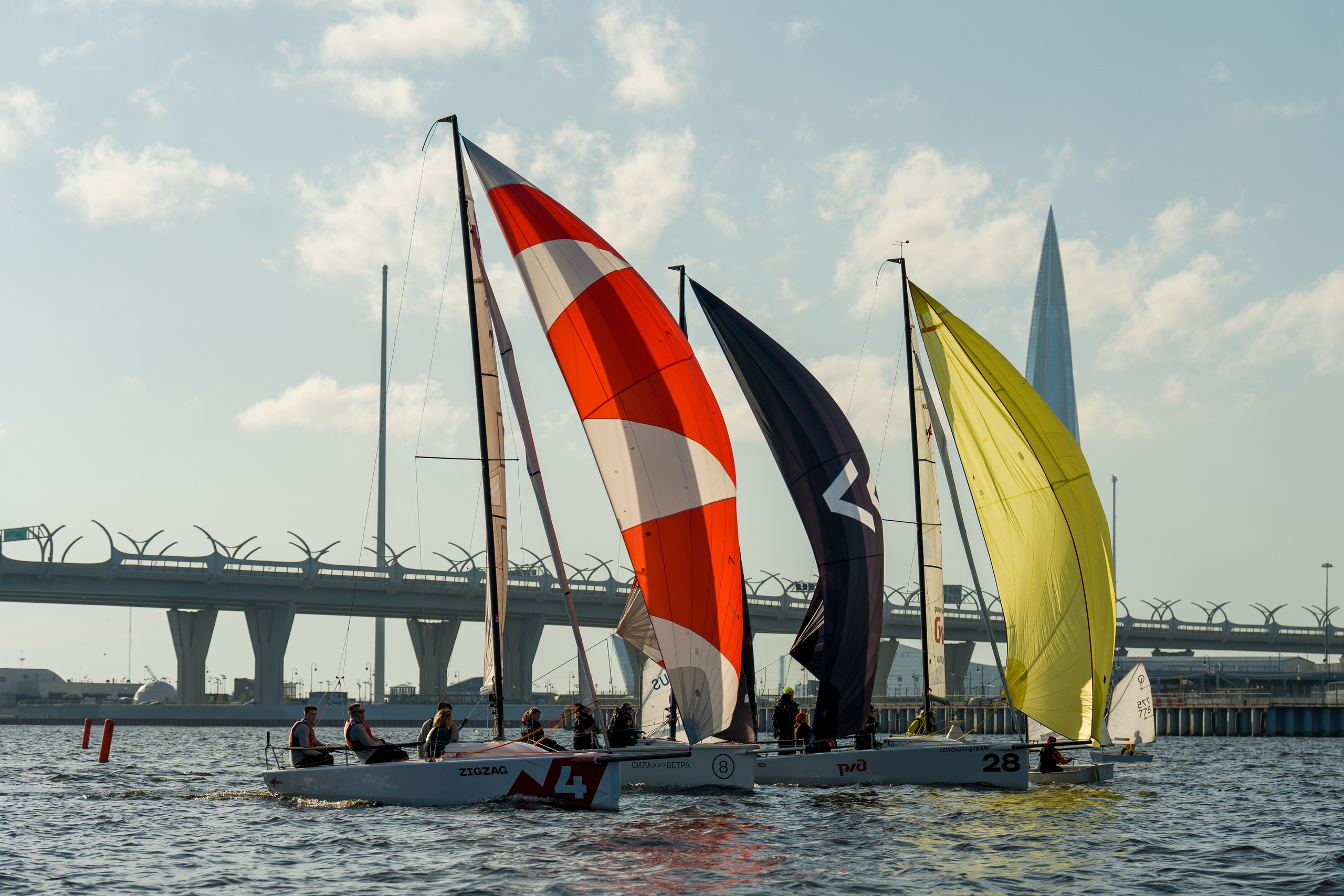 SV20s sail side by side under spinnakers on chilly May water
