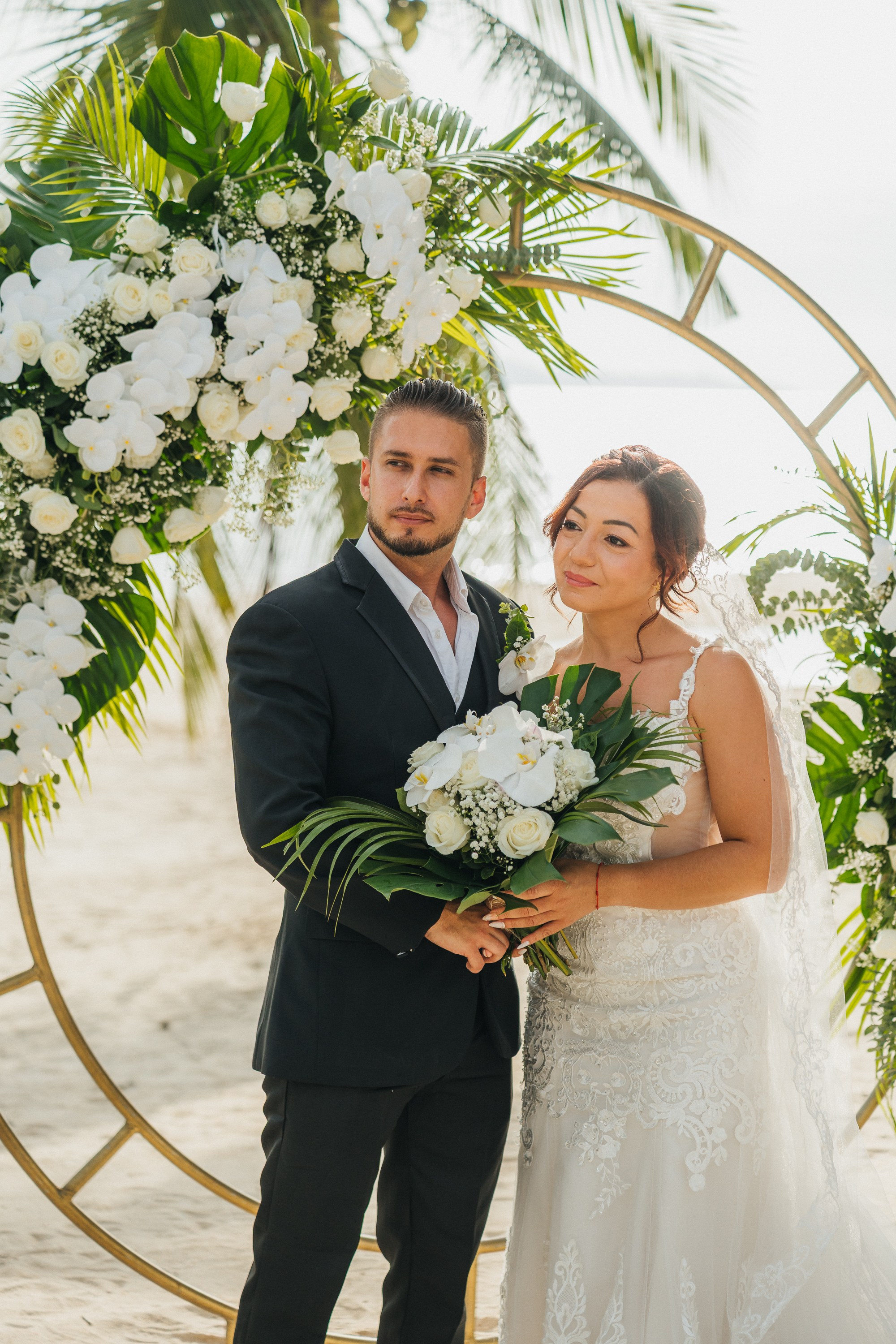 Intimate family wedding on the beach in Koh Samui, Thailand with the couple and their children enjoying the ceremony together