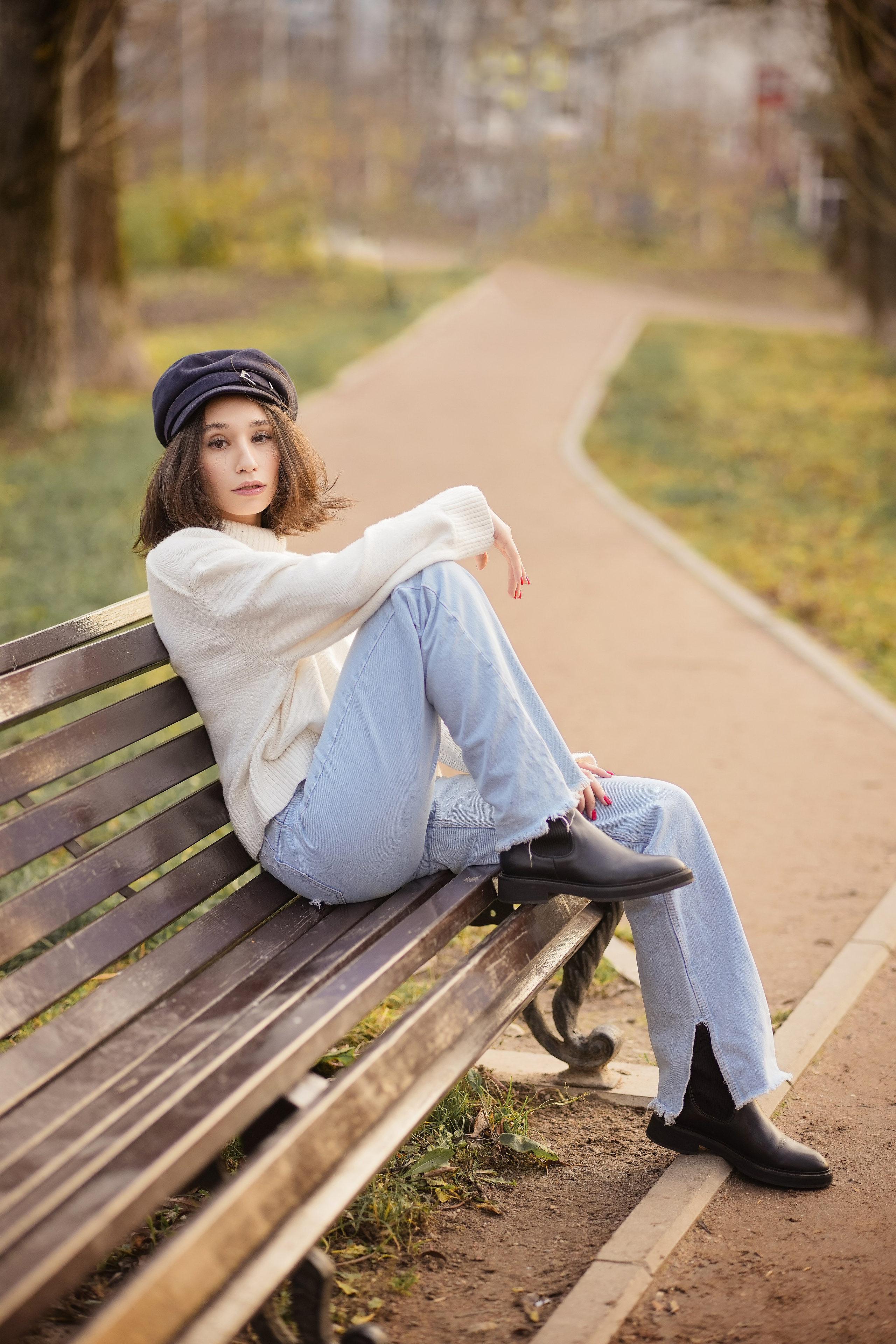 девушка в осеннем парке сидит на скамеечке