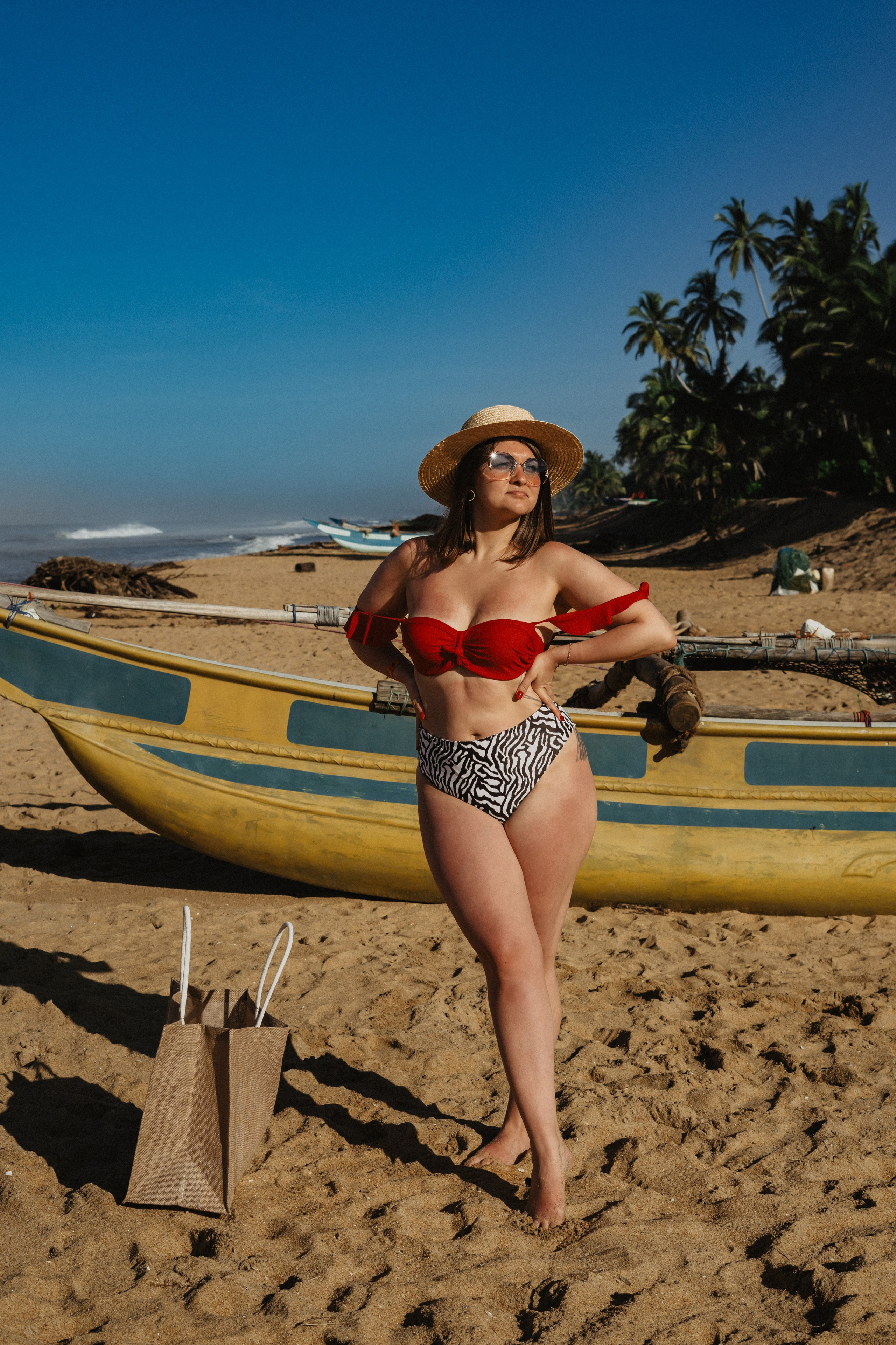 a girl in a straw hat enjoying a beach photoshoot