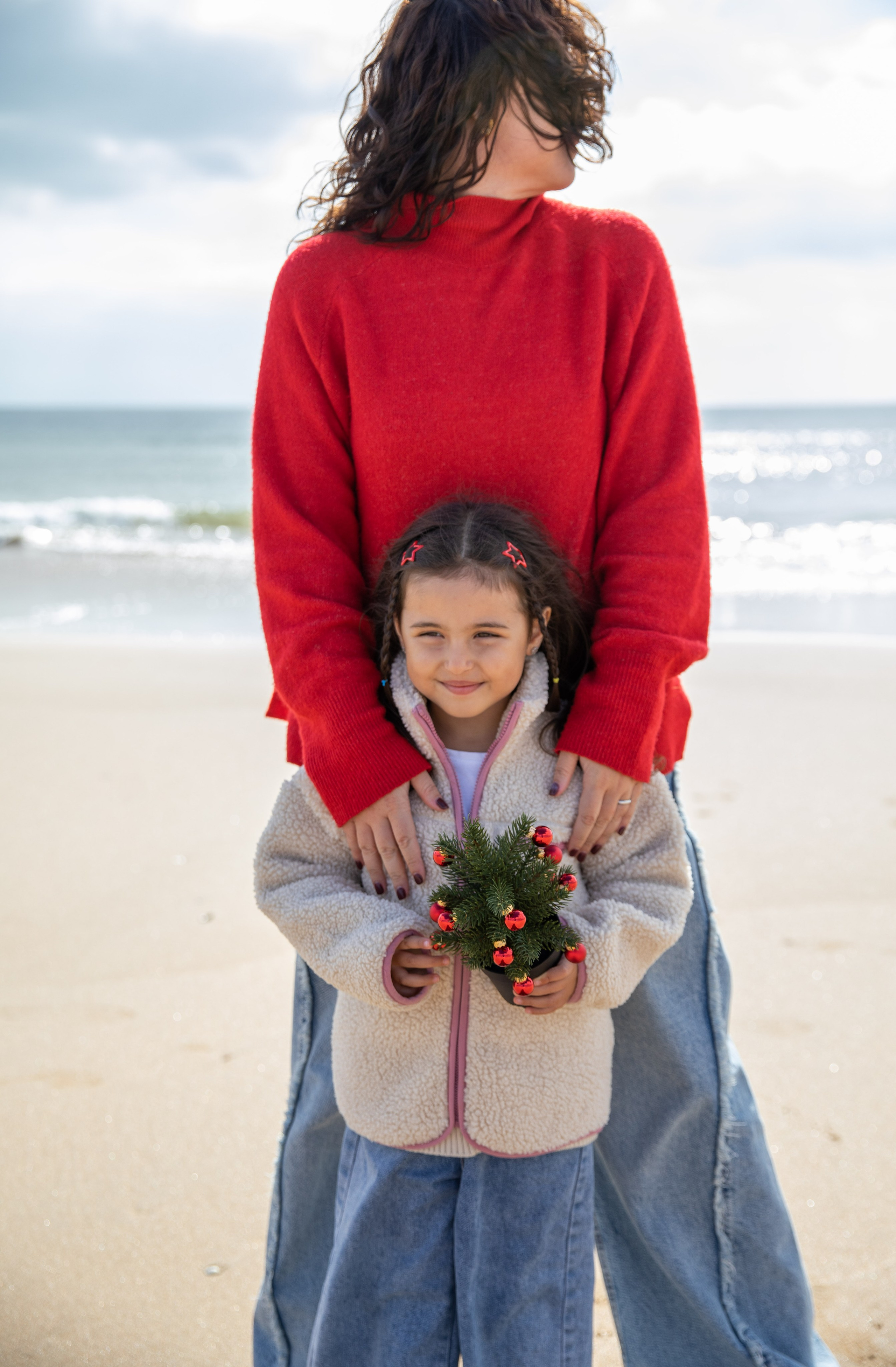 A beautiful moment of connection, as mum and daughter gaze out at the ocean together