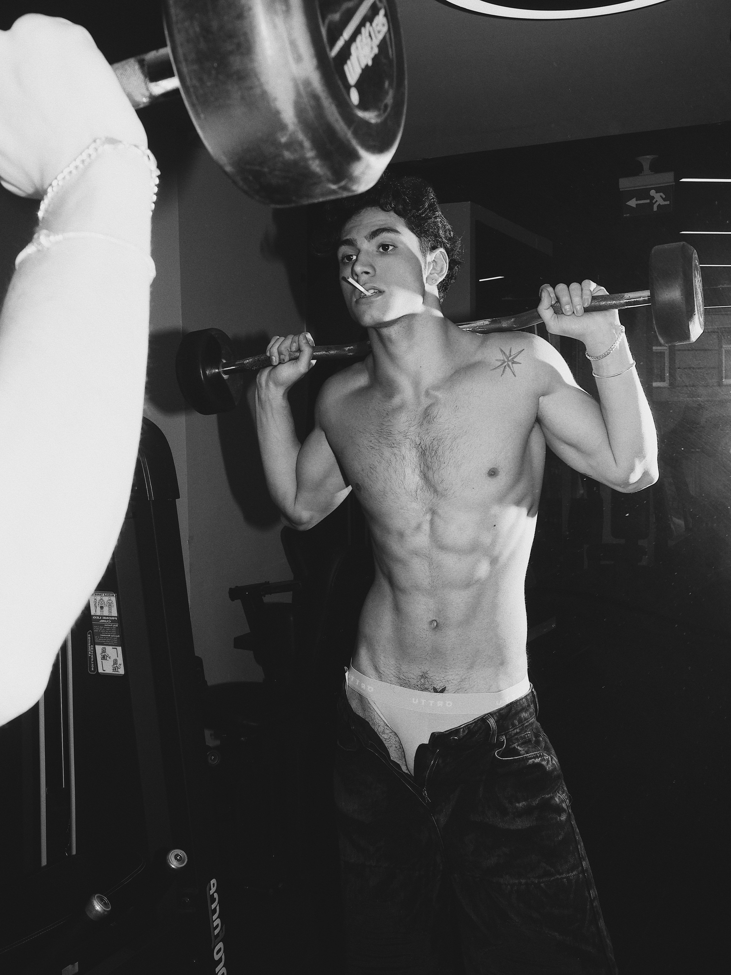 Black and white men’s fitness fashion photoshoot with athletic male model in gym, Sergio Maiis