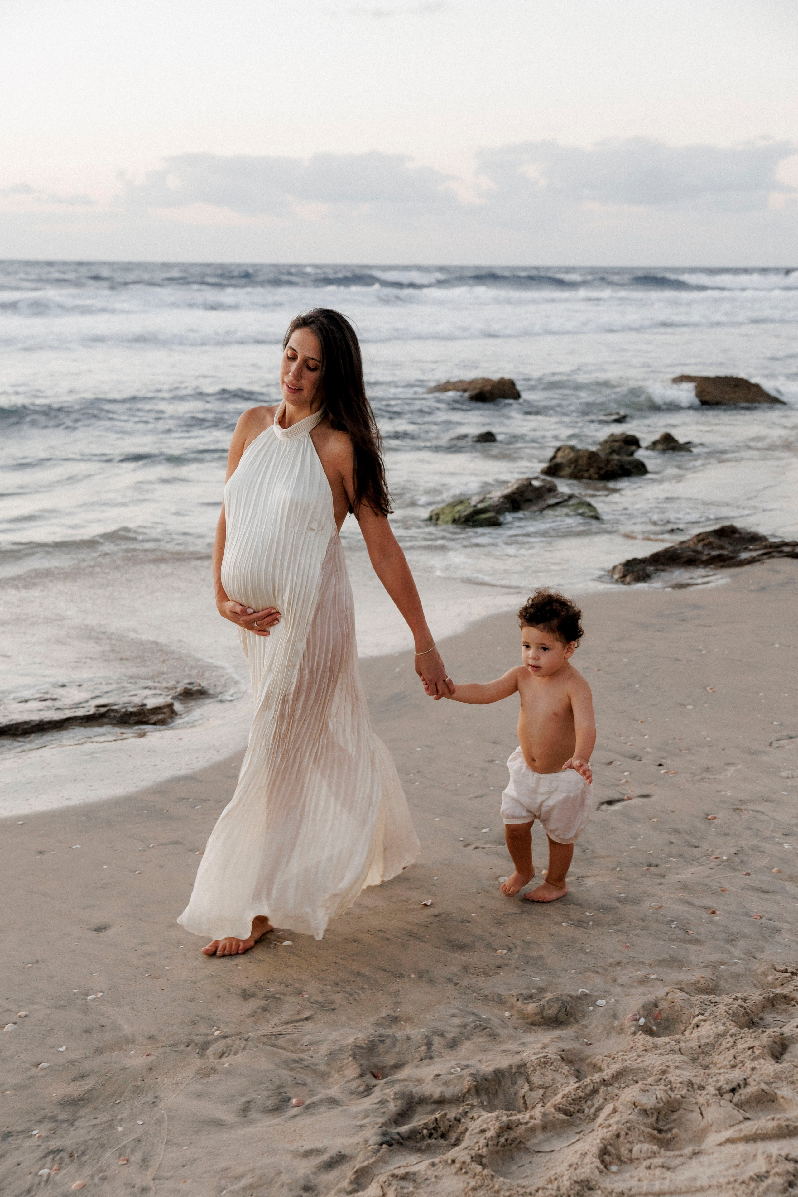 Pregnancy photoshoot near the sea. Wedding and family photographer