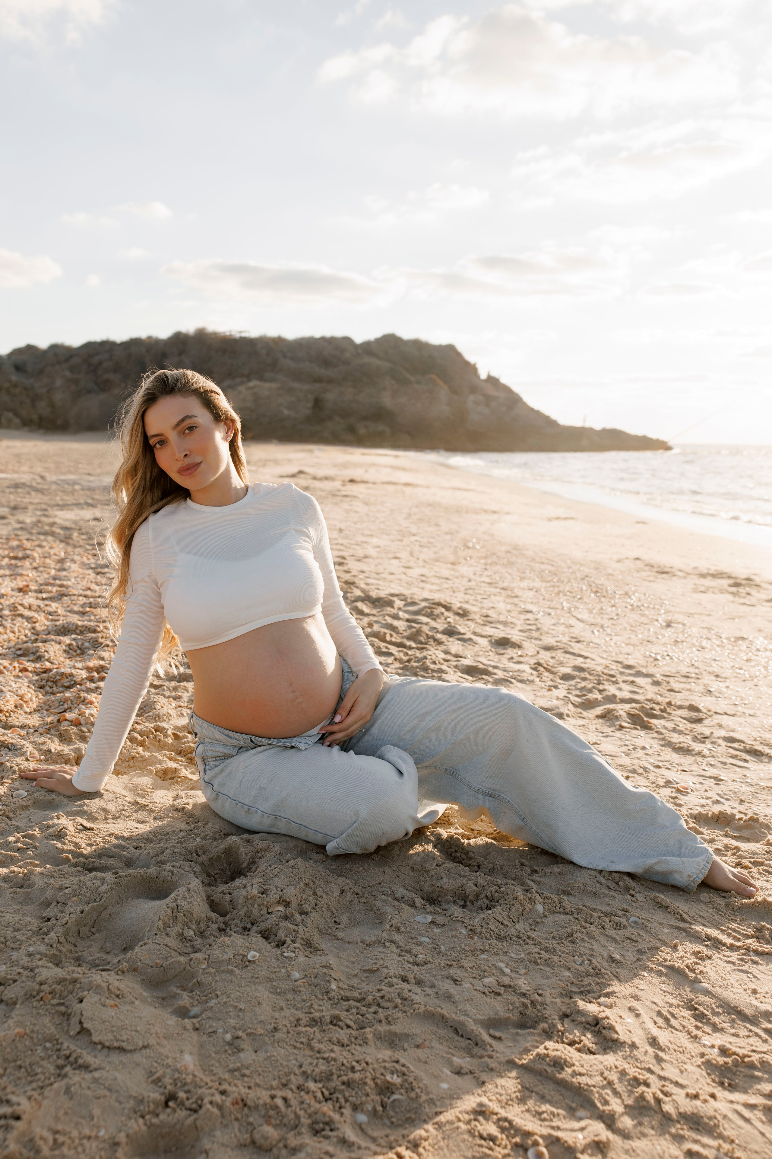 Pregnancy photoshoot near the sea. Wedding and family photographer