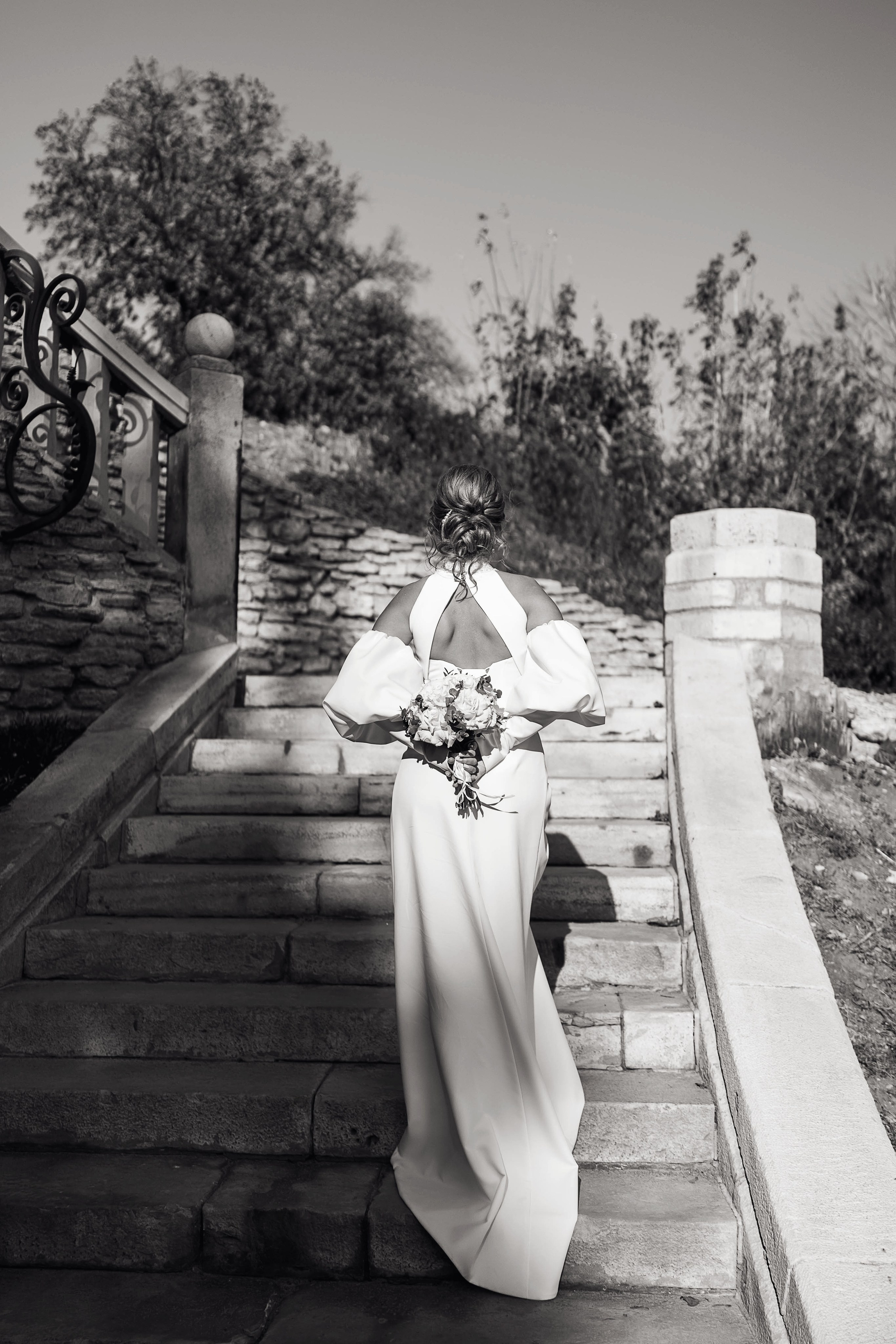 Невеста стоит на лестнице, держит букет в Замке Ольденбургских в Воронеже