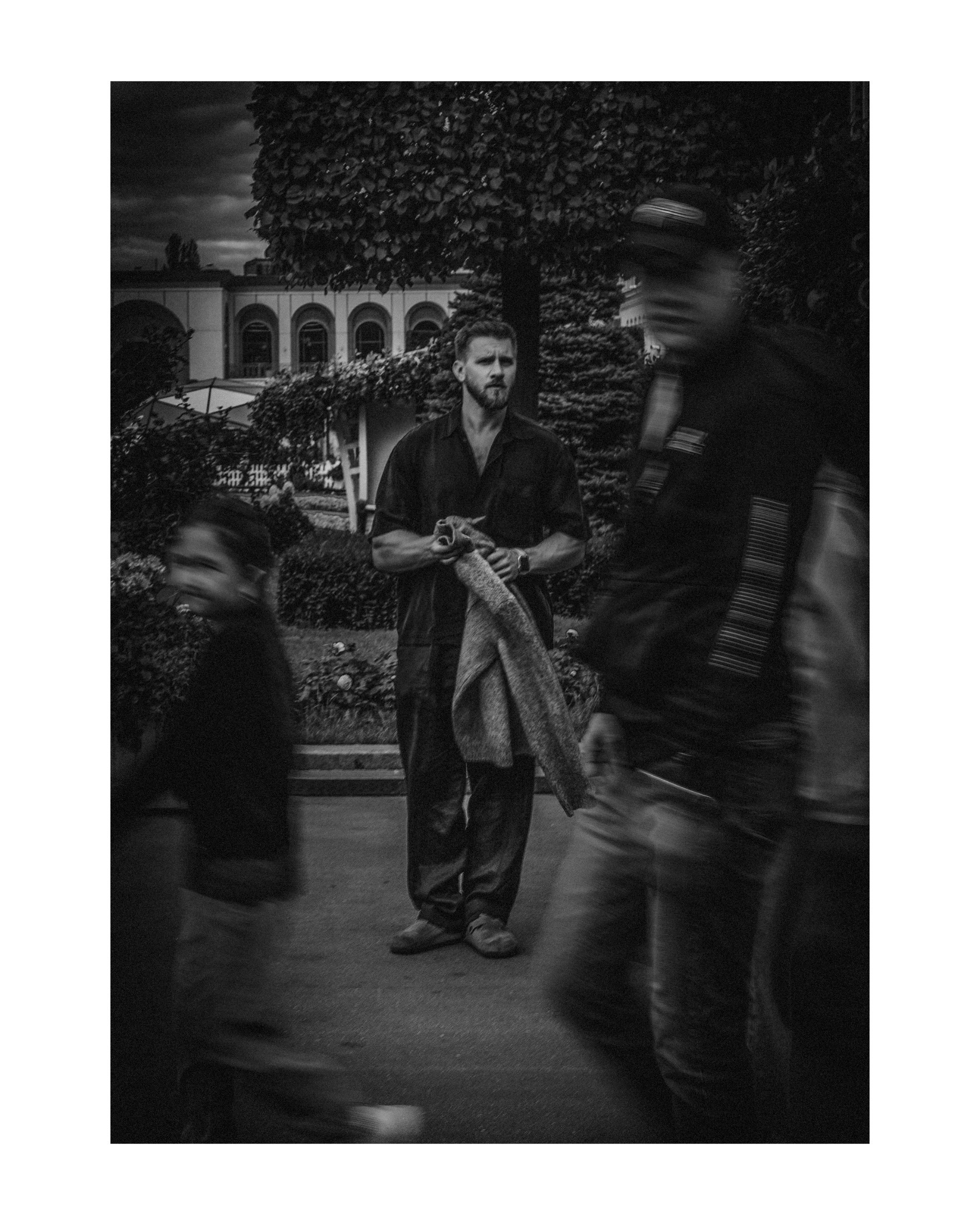 портрет мужчины на фоне движущихся людей