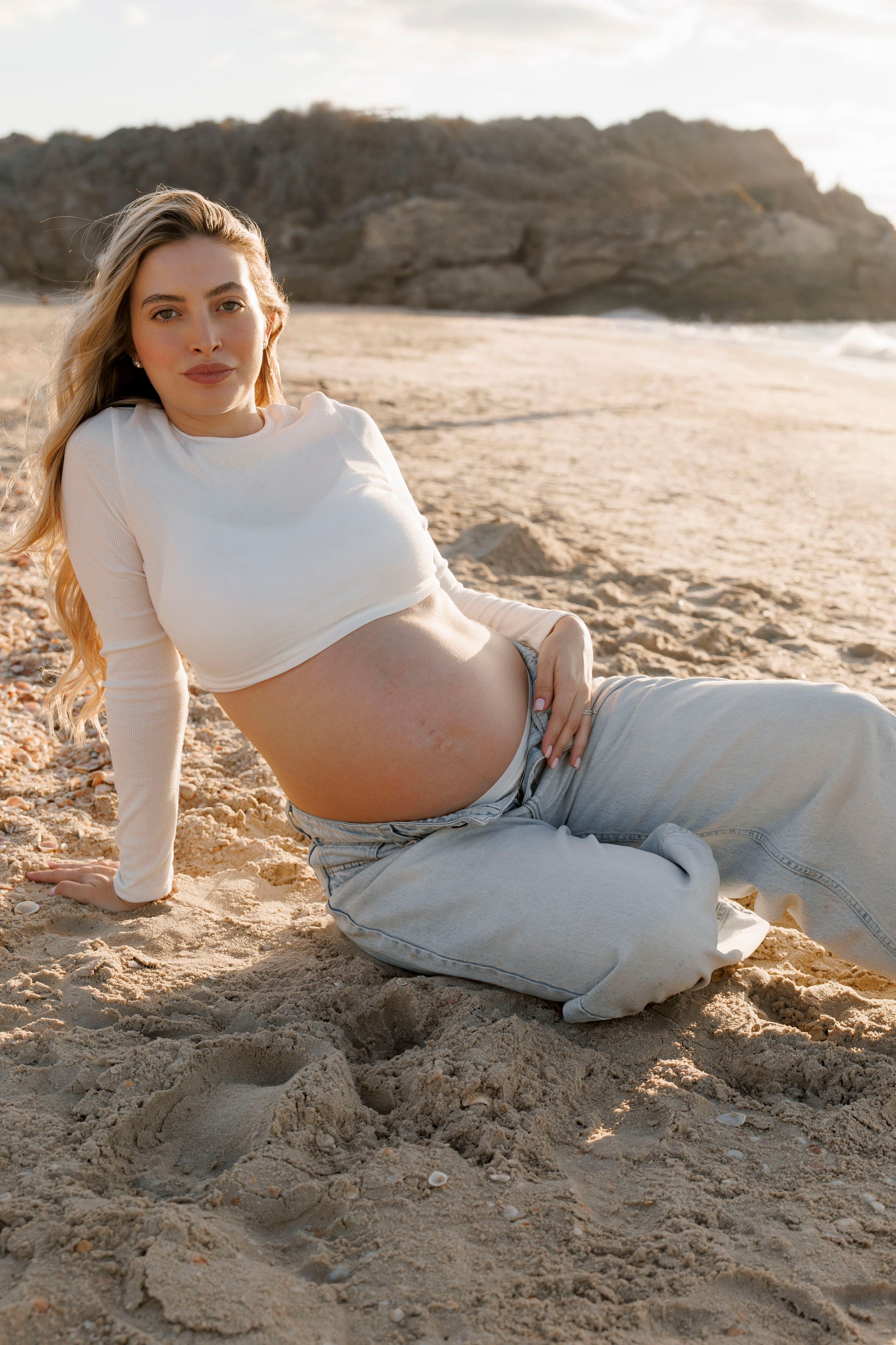 Pregnancy photoshoot near the sea. Wedding and family photographer