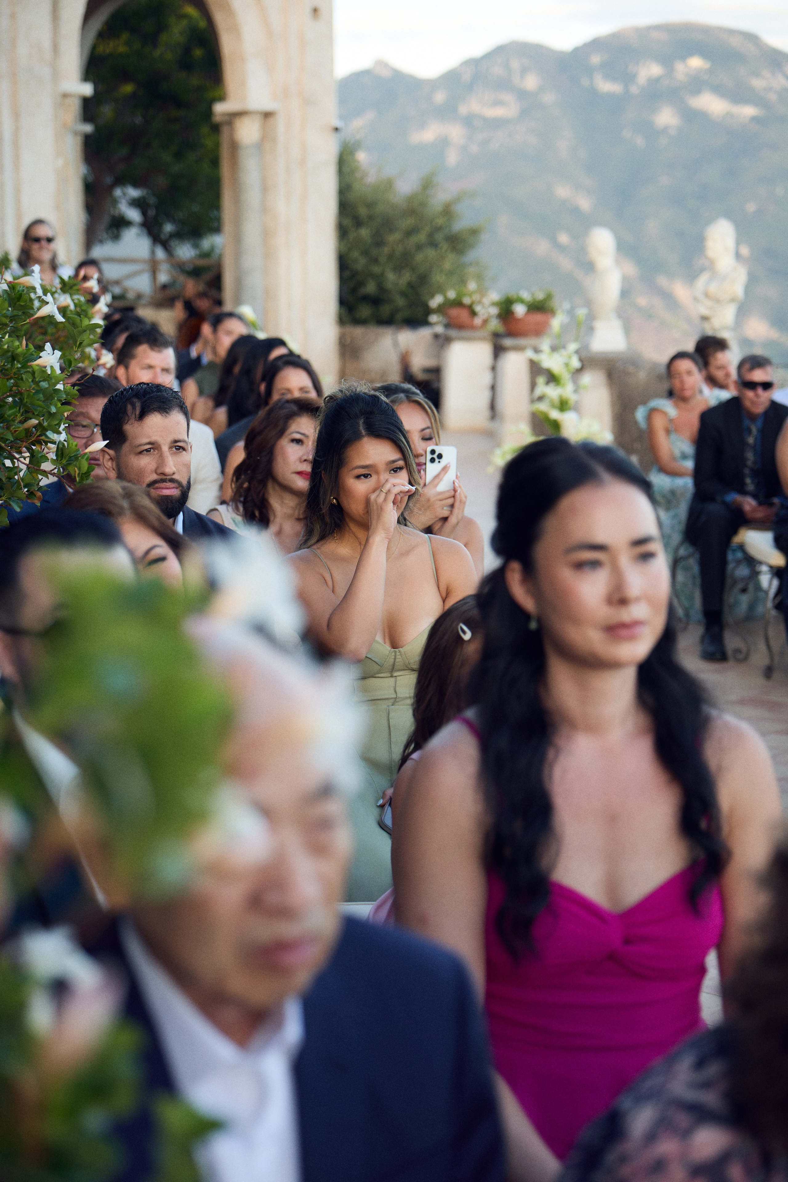 Wedding guests seated on the terrace during the ceremony