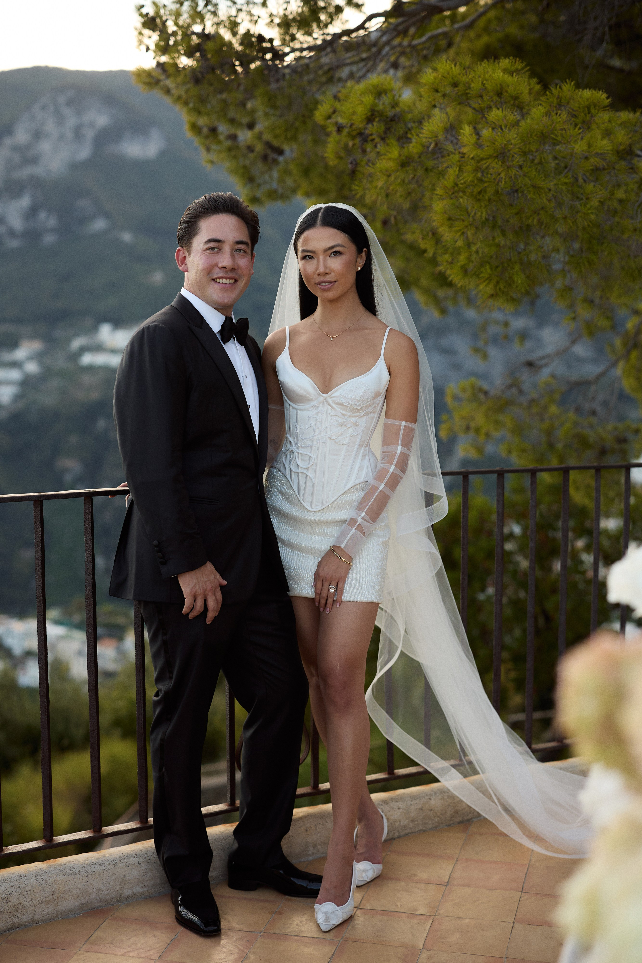 Bride and groom posing together on a terrace at Villa Cimbrone