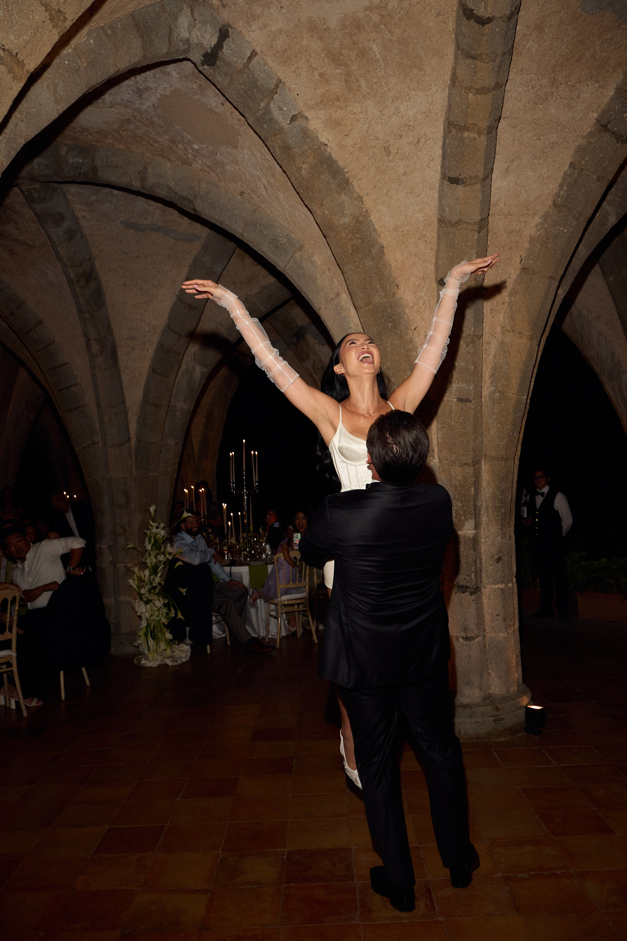 Groom lifting the bride during their wedding dance