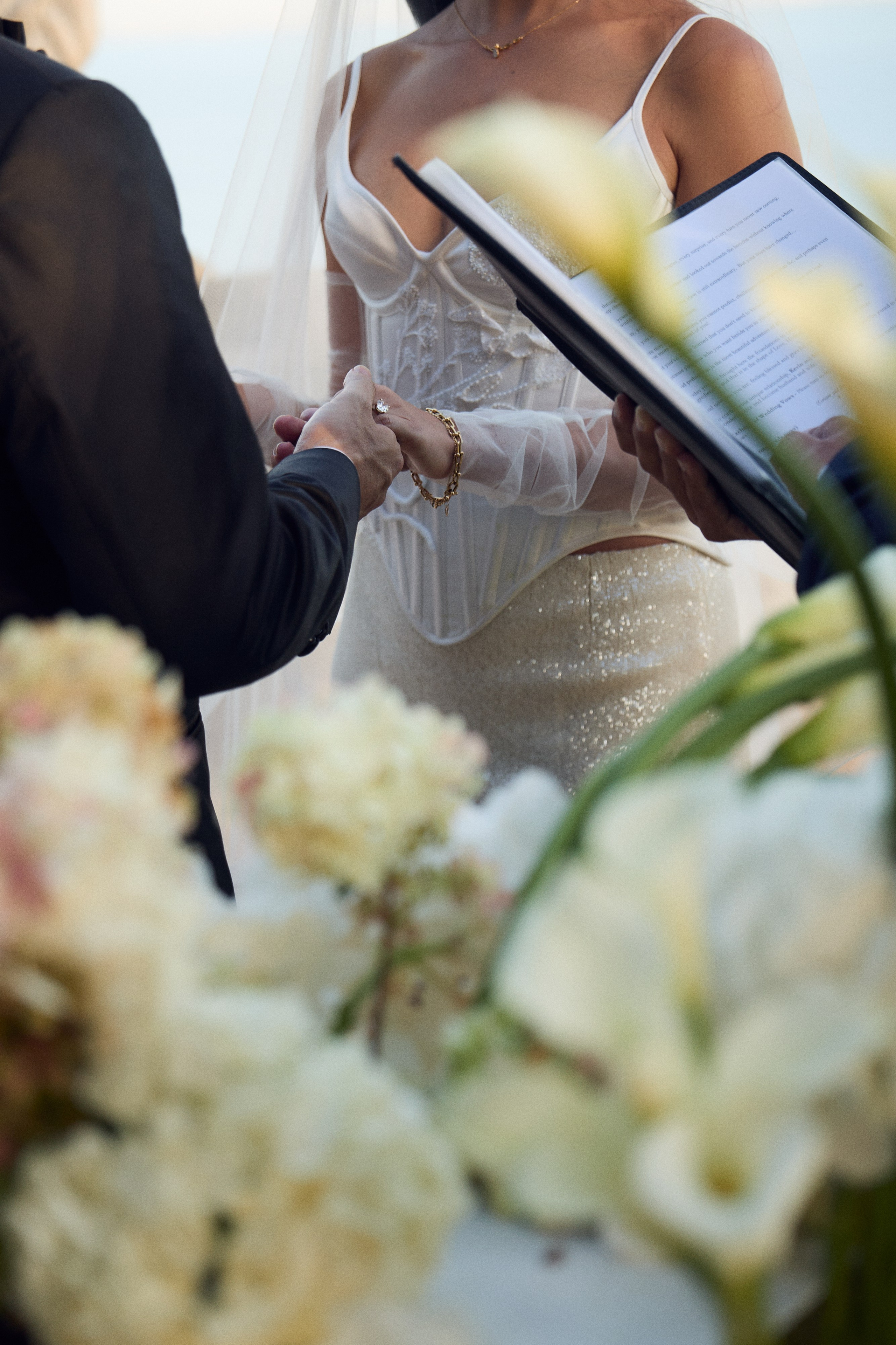 Close-up of the couple holding hands during the wedding ceremony