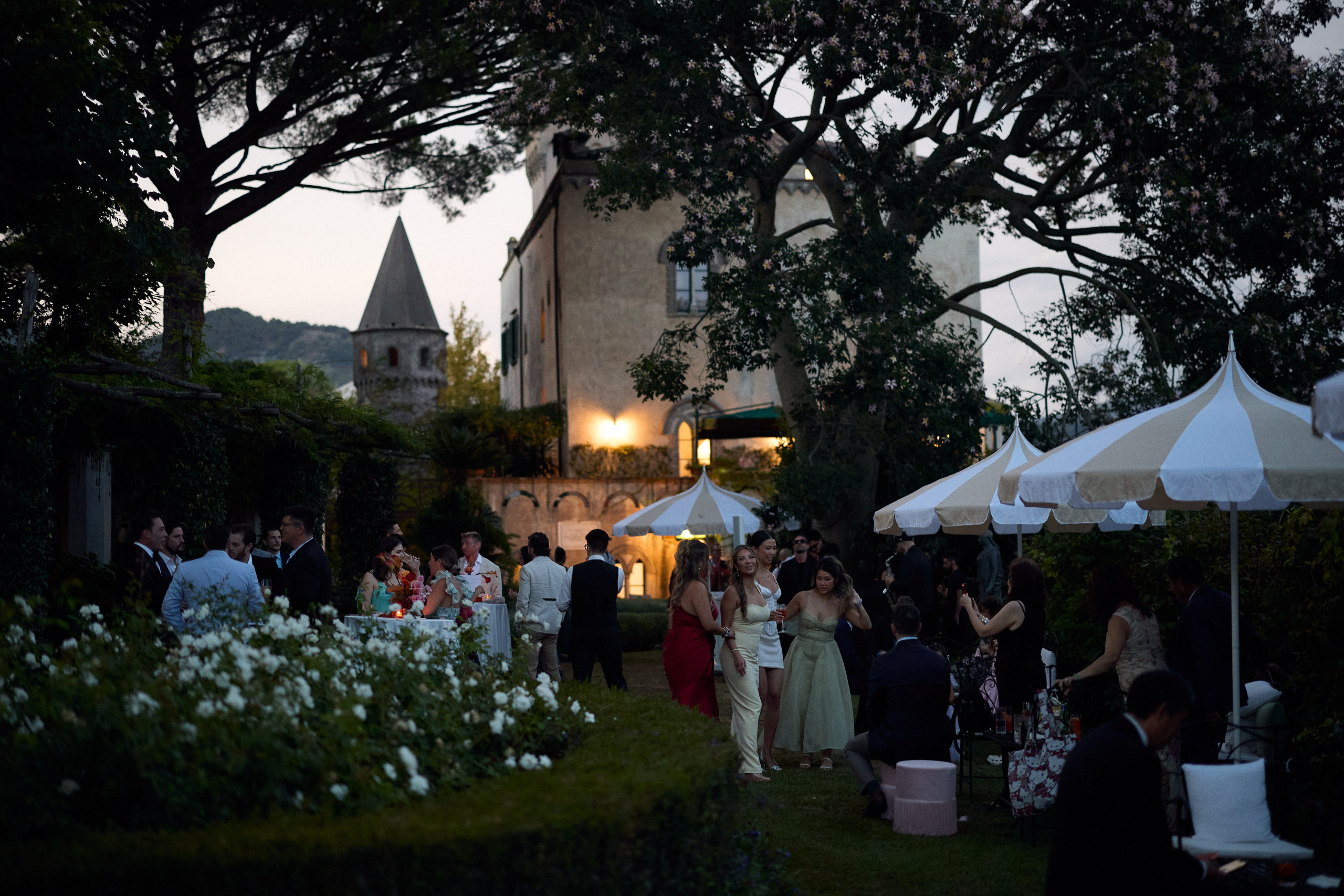 Guests gathered in the gardens of Villa Cimbrone at dusk