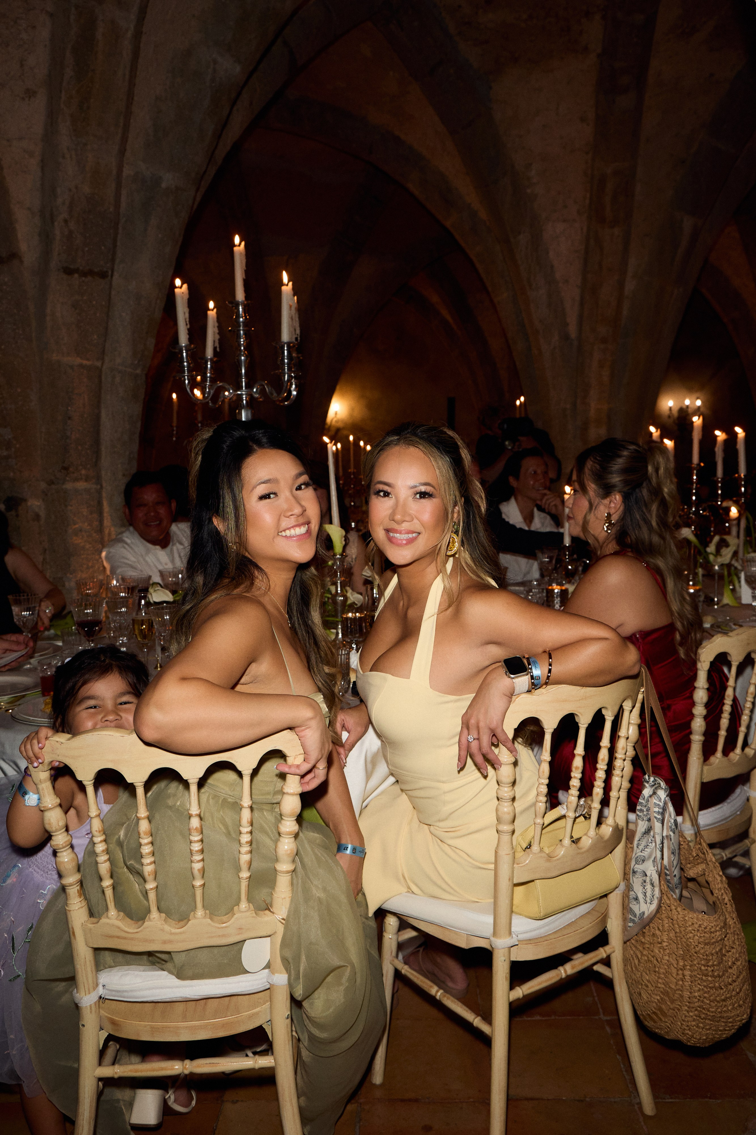 Guests seated at the wedding reception beneath stone arches