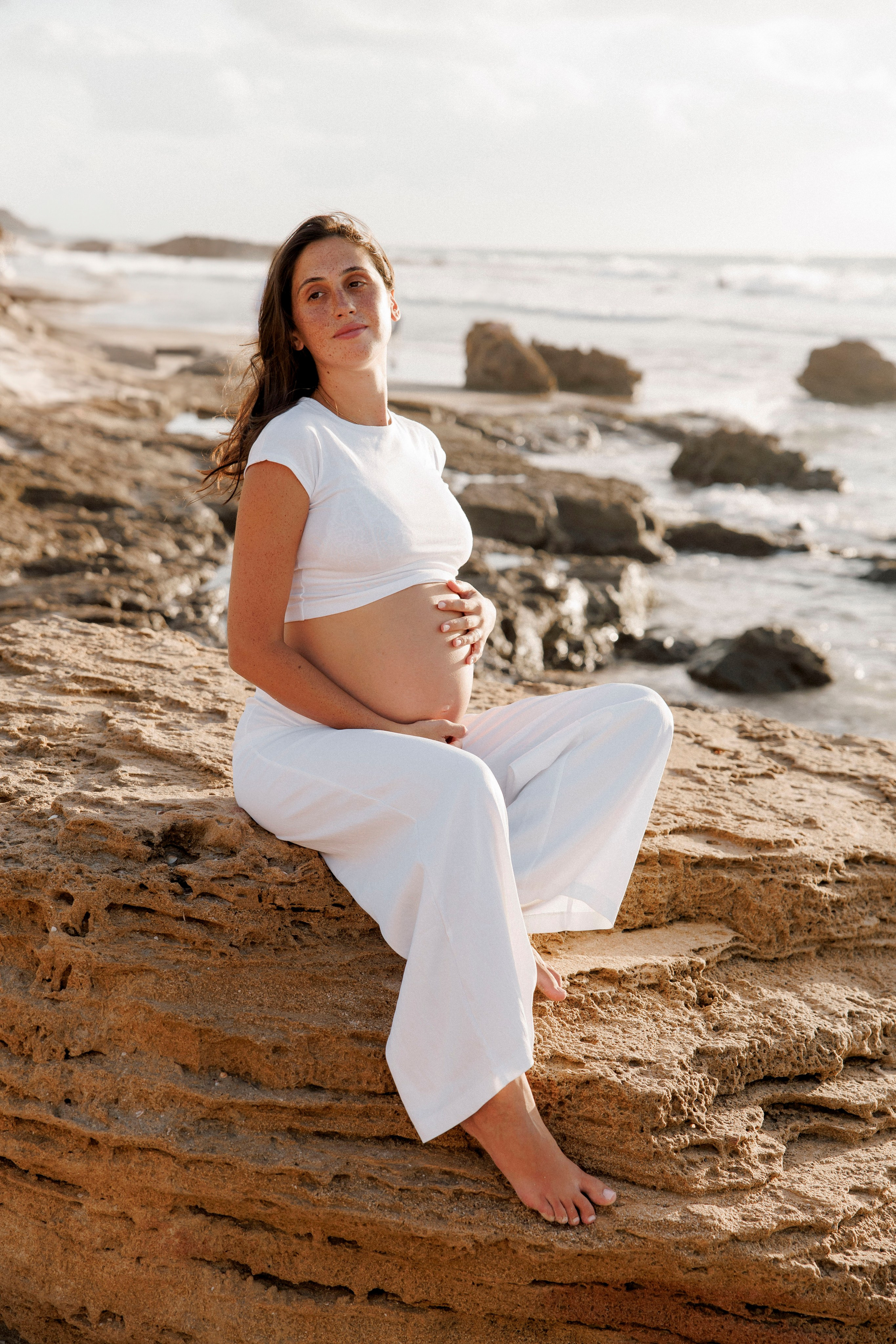 Pregnancy photoshoot near the sea. Wedding and family photographer