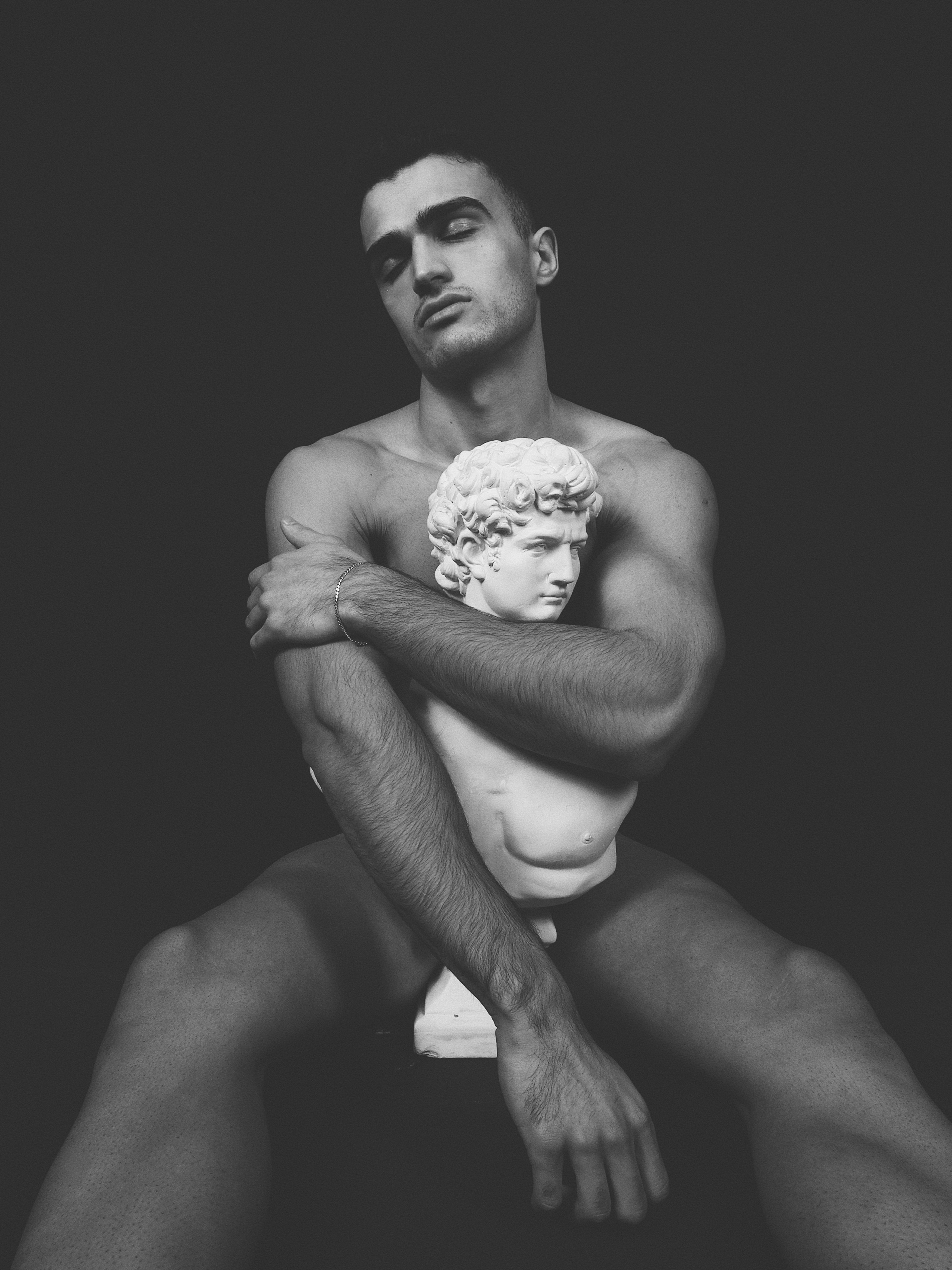 Black and white artistic male nude portrait with classical sculpture, fine art fashion photography, Sergio Maiis
