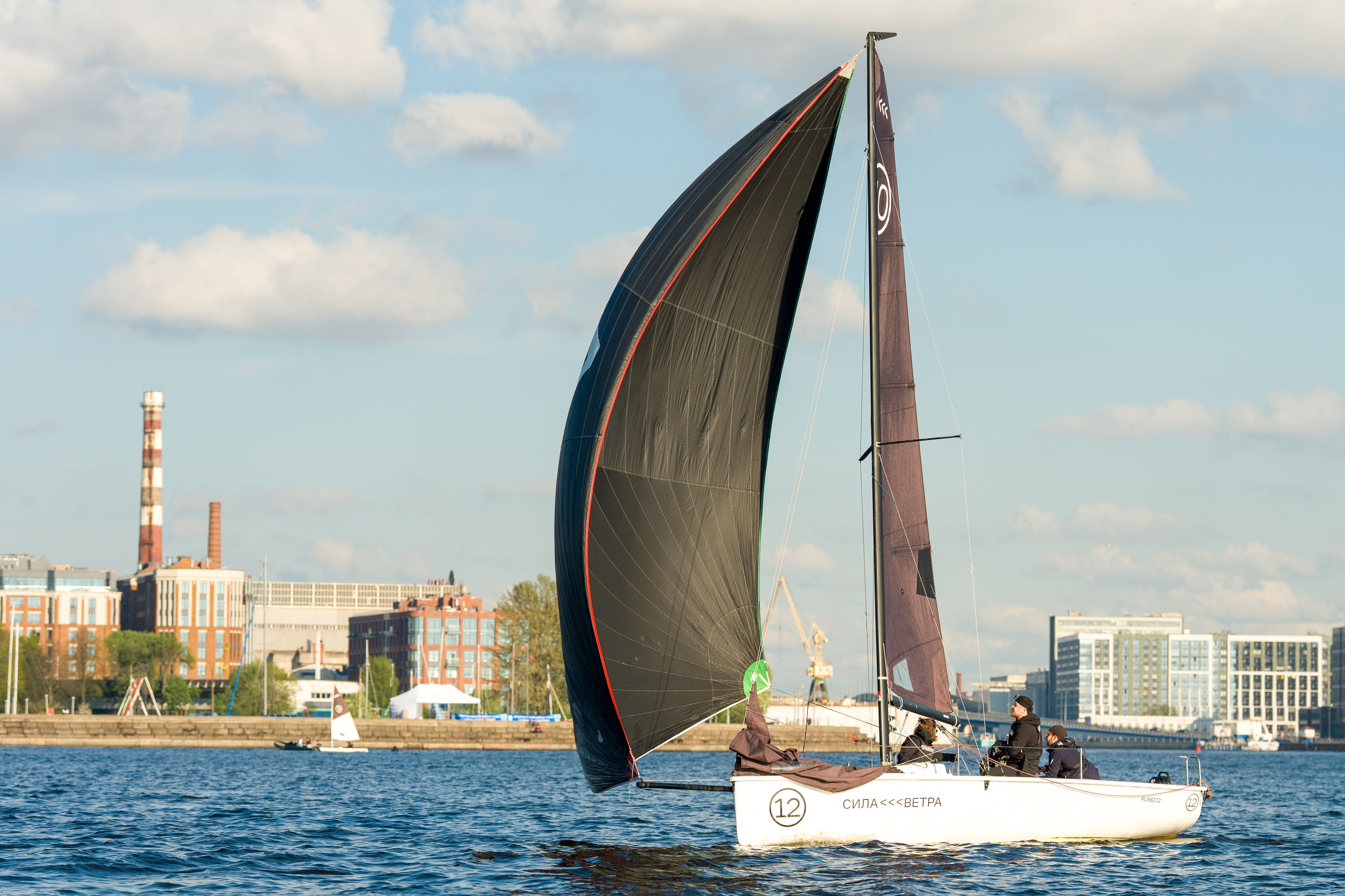 SV20 crew powers under a big spinnaker along St Petersburg waterfront