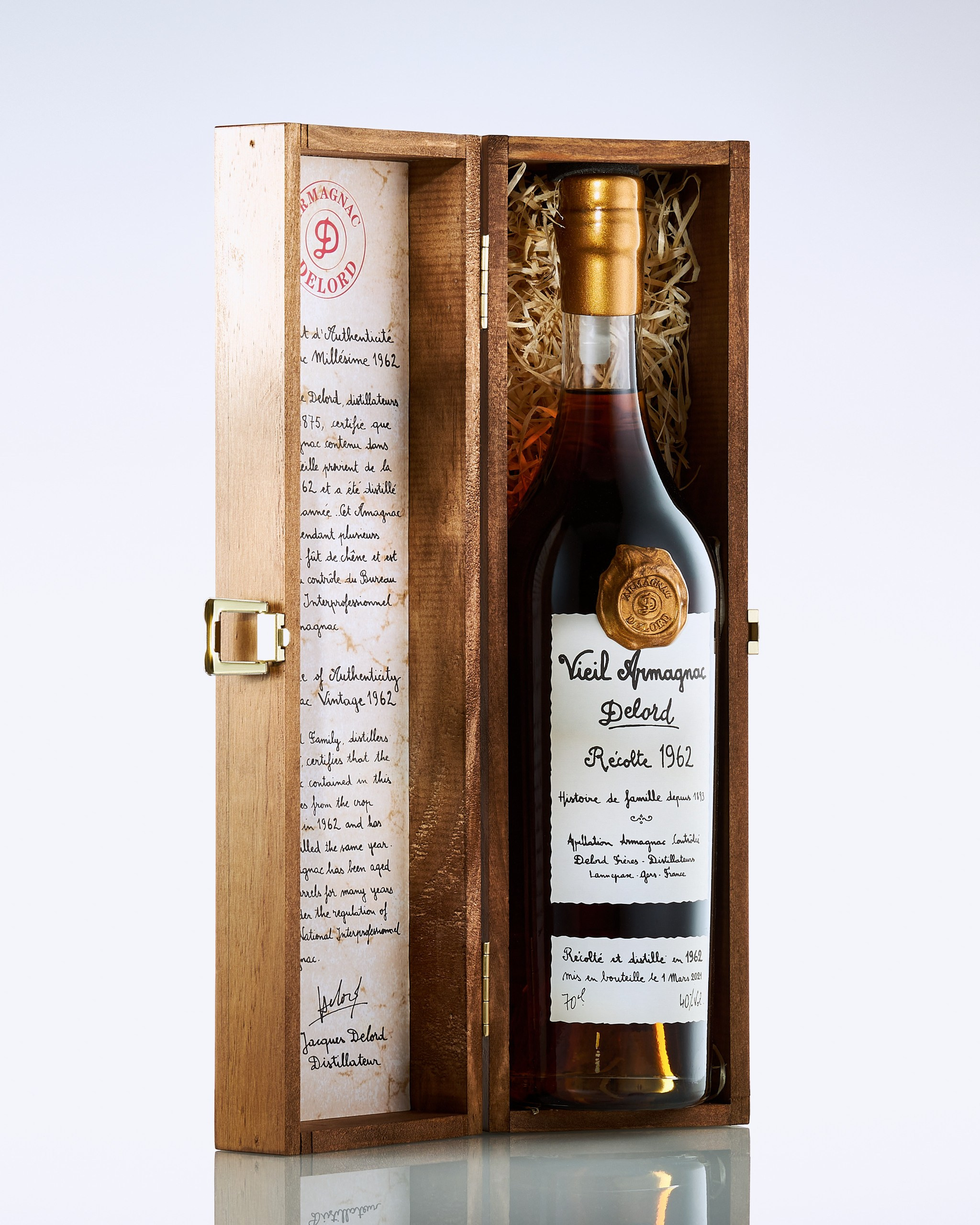 Бутылка коллекционного коньяка Armagnac Delord в открытой деревянной коробке
